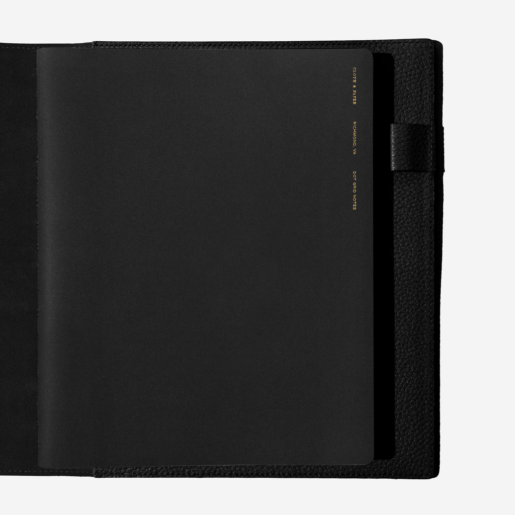 Notebook shown closed inside a black leather agenda. Color shown is Avant Garde.
