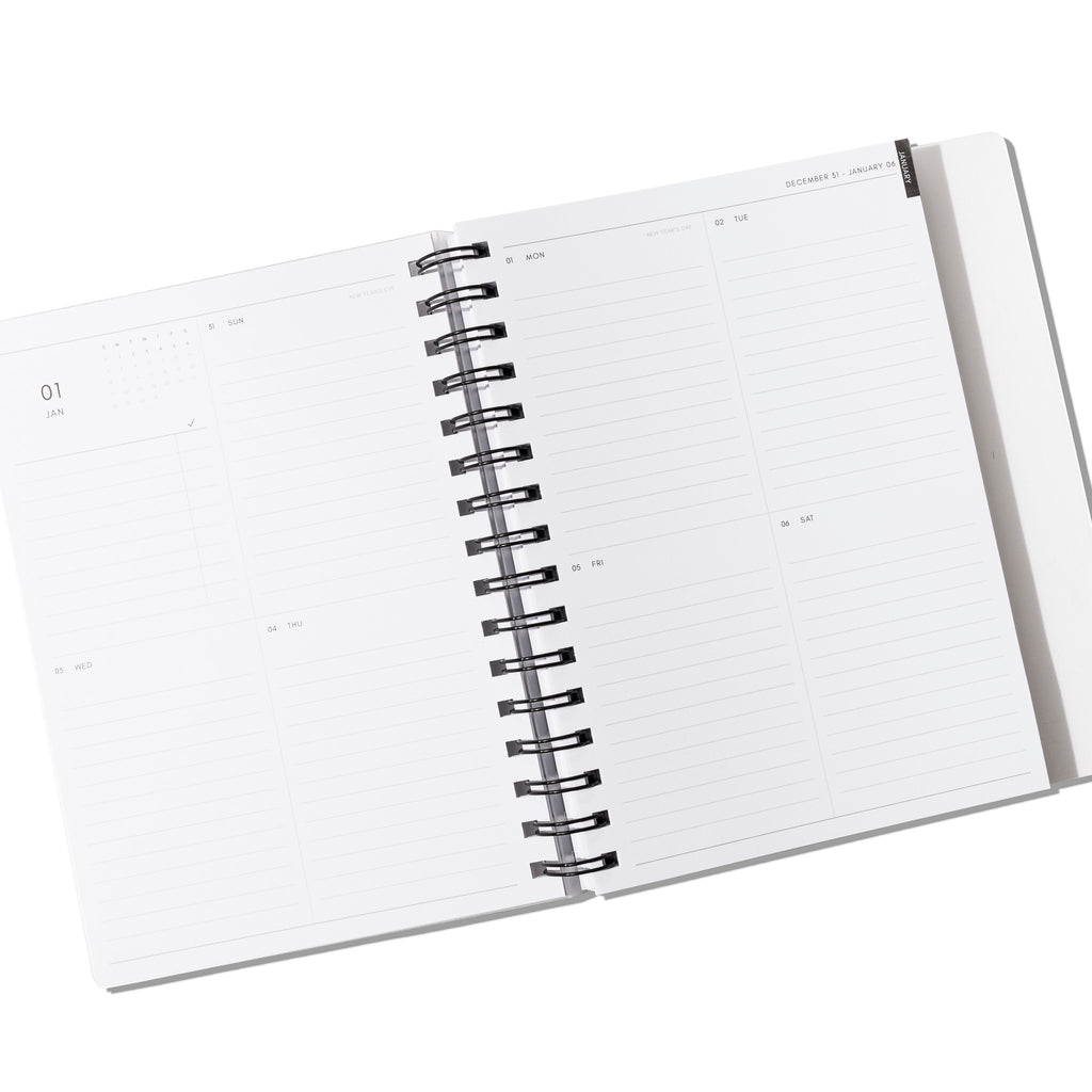 Vertical Weekly notebook displayed open on a white background.