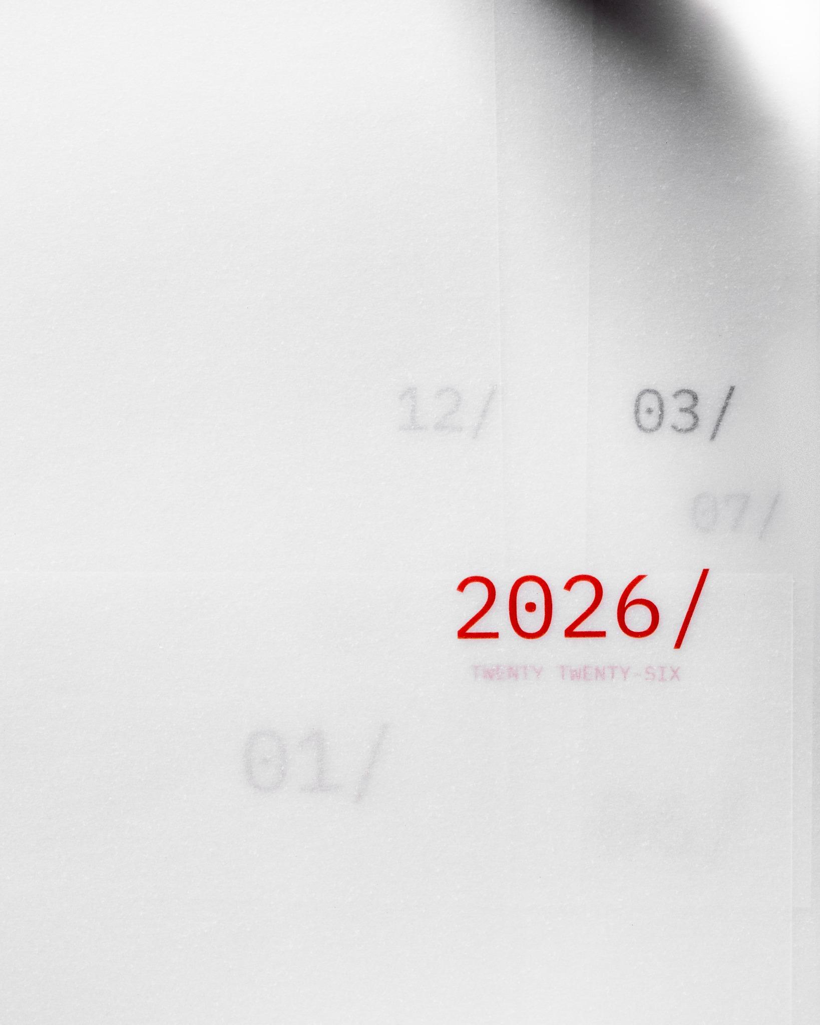 Overlapping vellum dashboards showing multiple months with '2026/' prominently printed in red