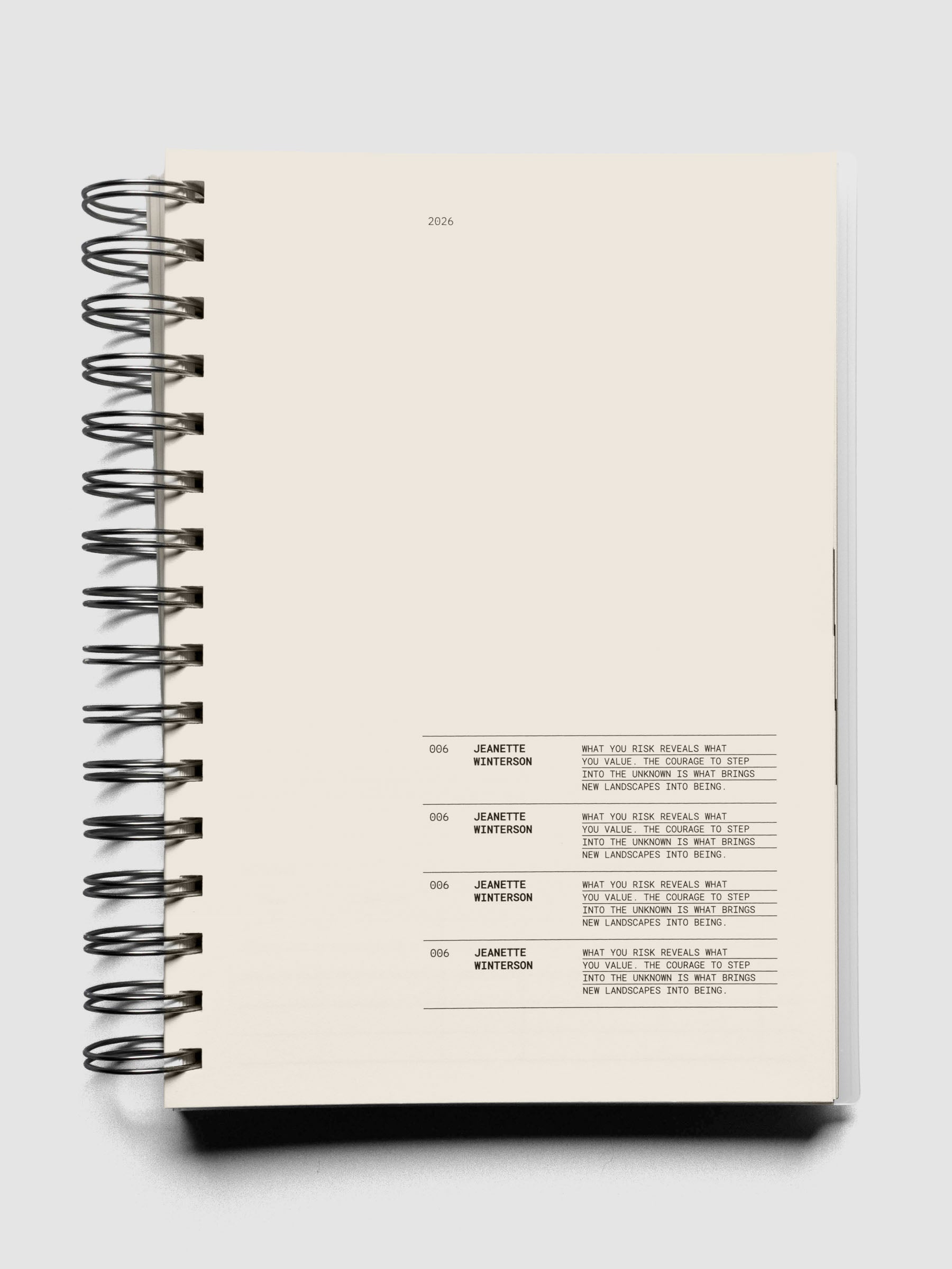 2026 Weekly Task Notebook shown open to a monthly page with quotes in black on cream paper.