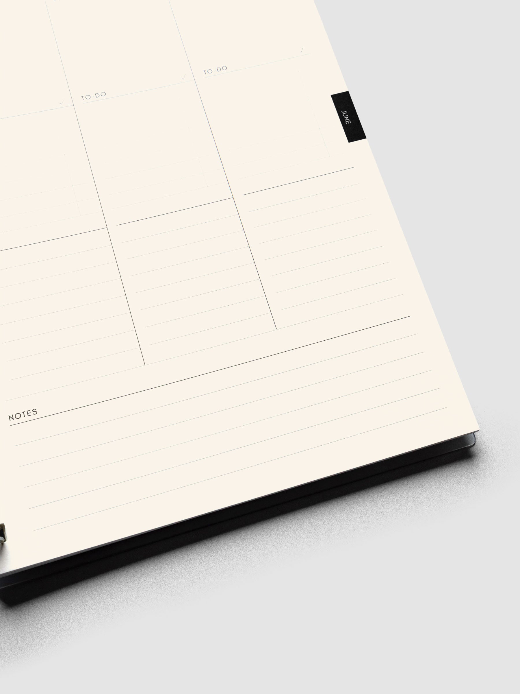 Close up of a weekly task layout page on cream paper showing lined notes section at the bottom of the page.