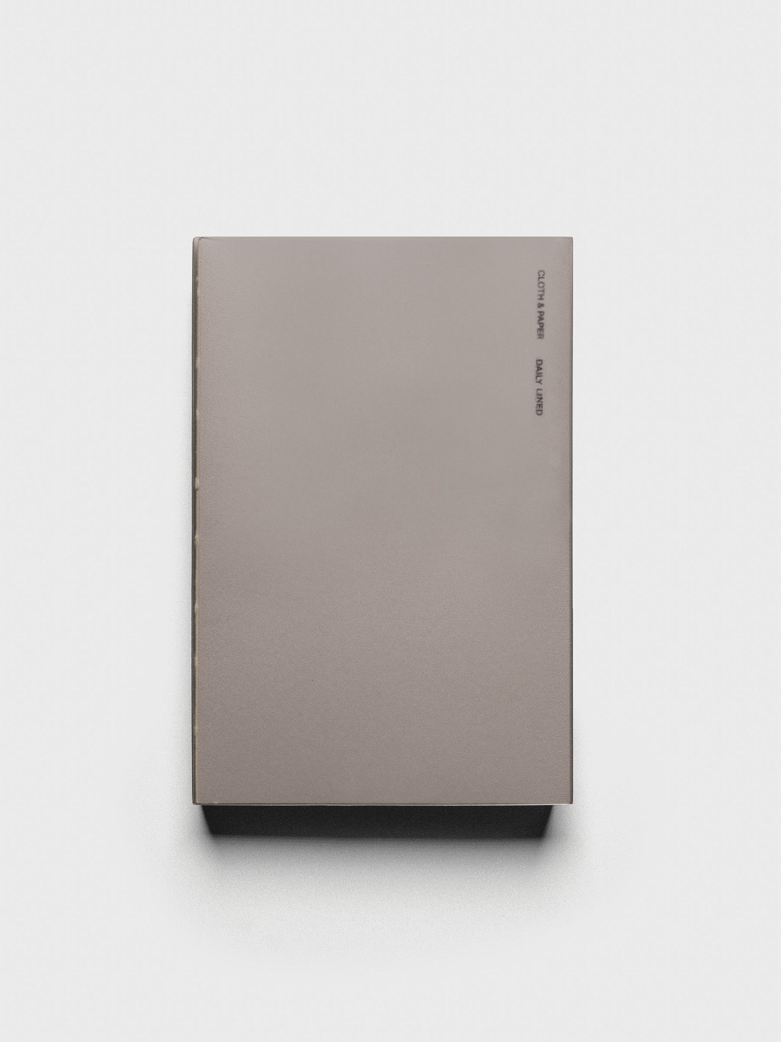 Perfect Bound Notebook | CP Petite | Daily Lined | Verona shown closed, laying flat, on a neutral background.
