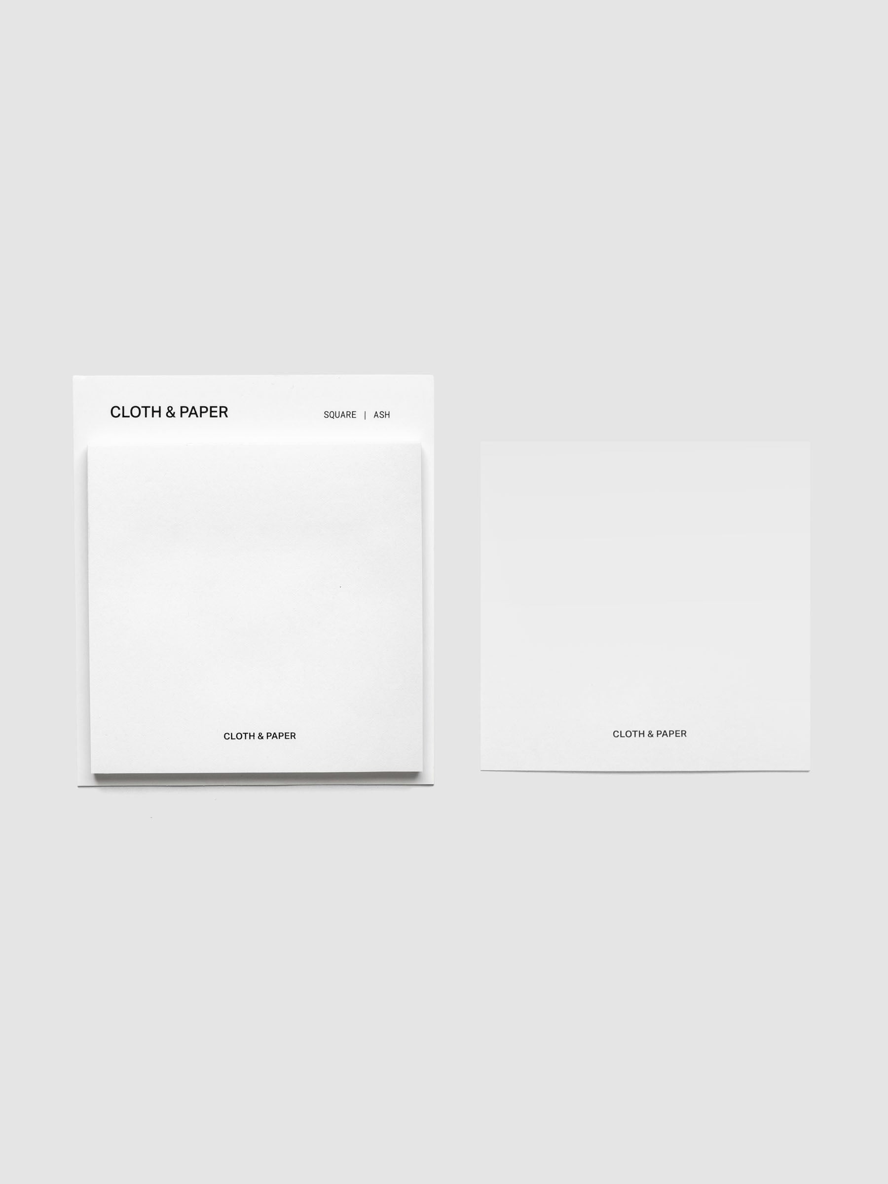 Sticky note set displayed against a neutral background. One note is placed on the packaging's edge. Color shown is Ash.