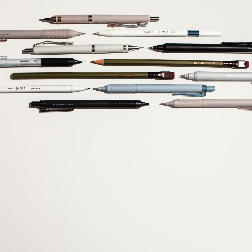 A collection of new pencils are arranged side by side against a white background.