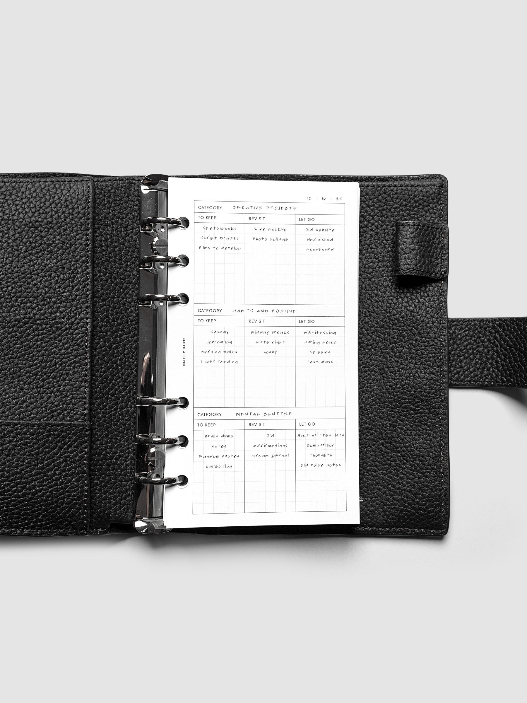 Declutter Planner Inserts with handwritten notes in size Personal shown ring bound in a black leather agenda.