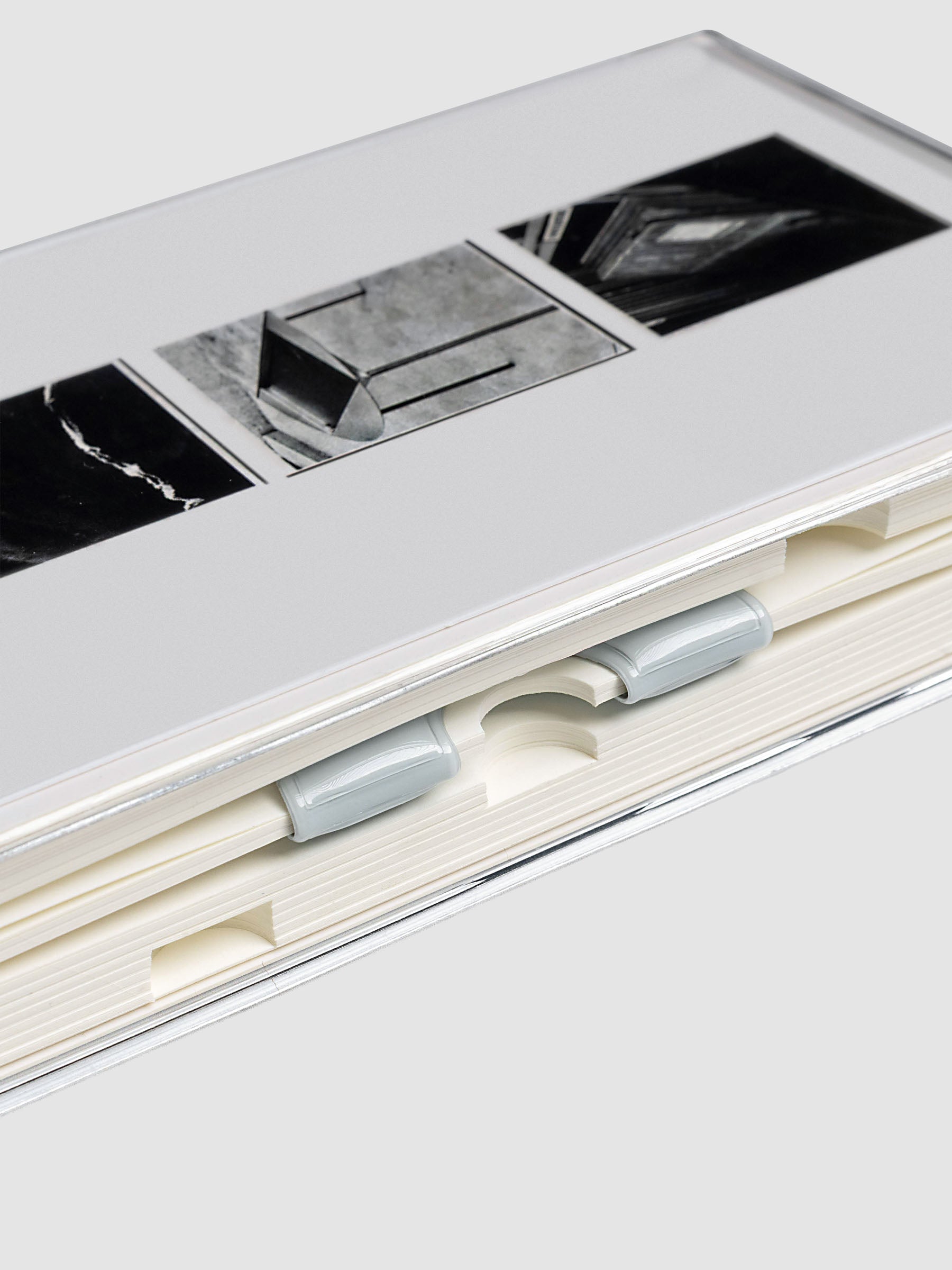 Magnetic Bookmark | Spotlight in the color Ash, a light grey, shown in use in a notebook