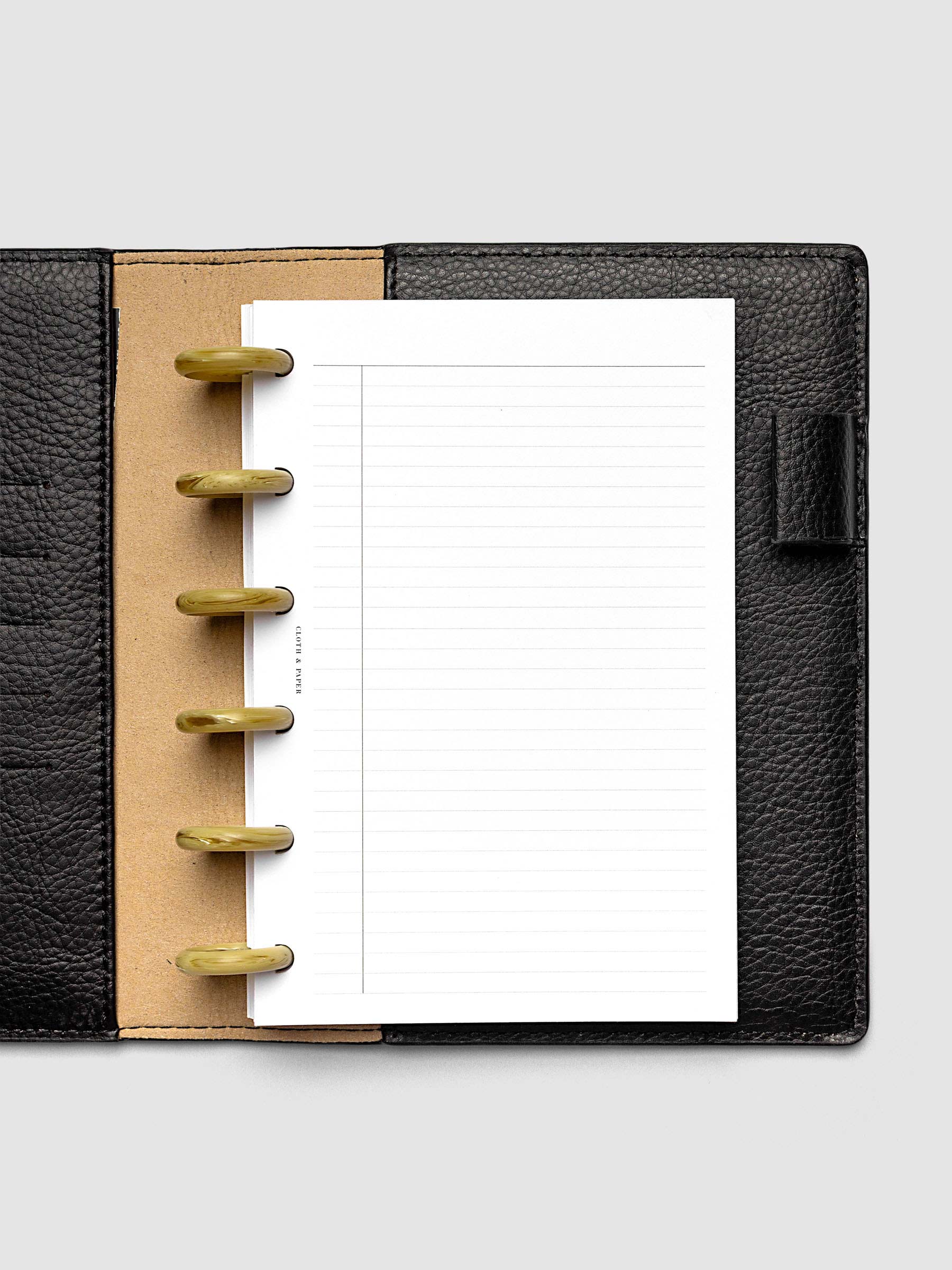 Carrara Verde 1" planner discs in use on an open discbound planner with pages secured on the discs