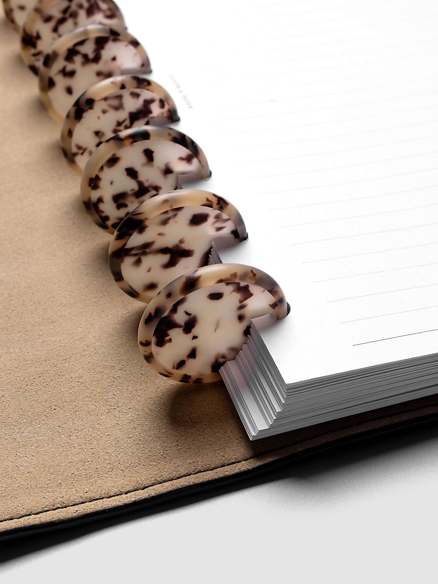 1.25" Inch Desert Tortoiseshell Planner Discs shown in use as binding with planner inserts.