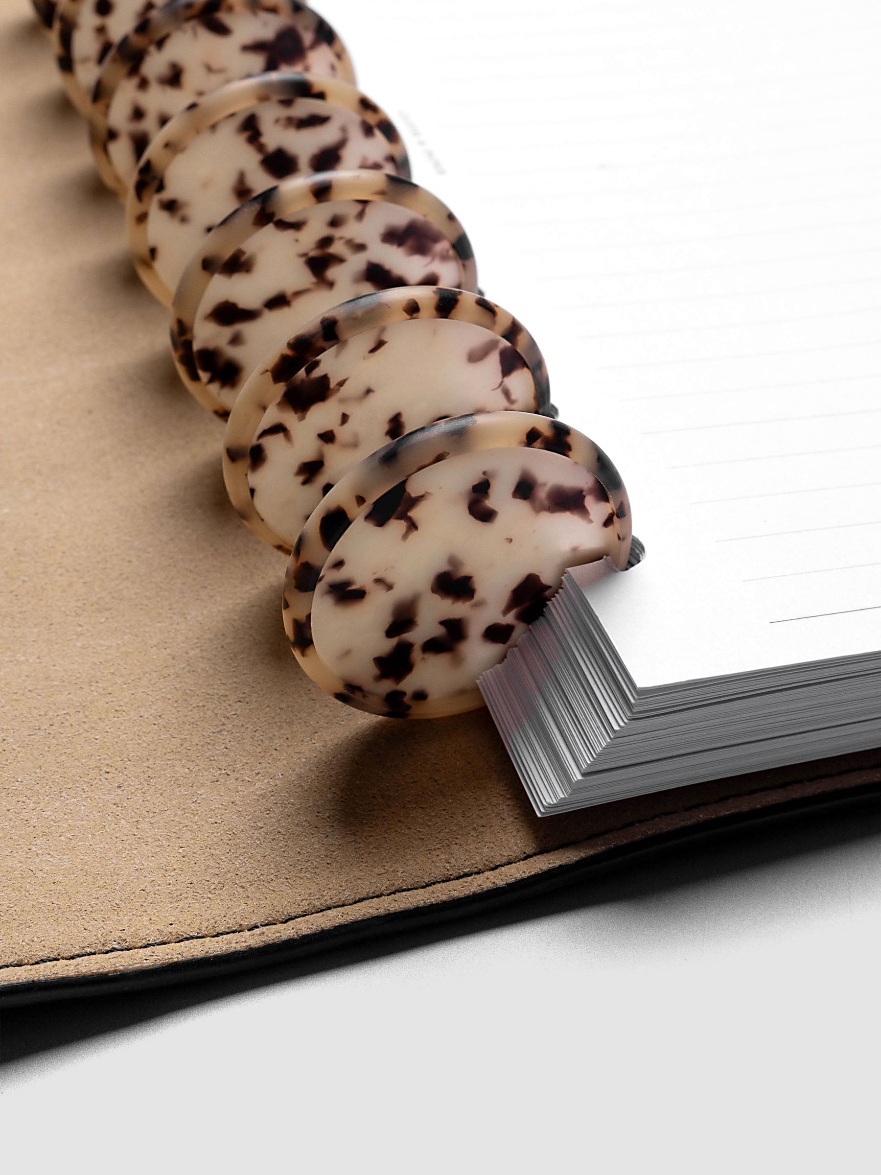 1.5" Inch Desert Tortoiseshell Planner Discs shown in use as binding with planner inserts.