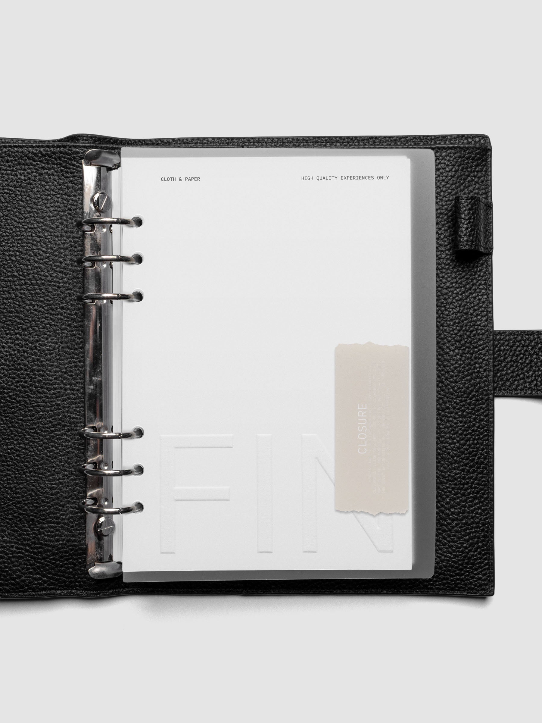Closure Planner Dashboard + Cover Set in size A5 shown ring bound in a black leather agenda.