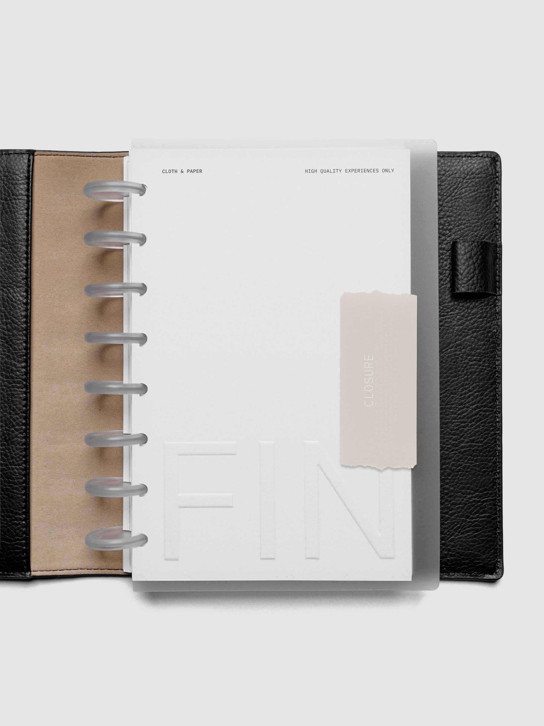 Closure Planner Dashboard + Cover Set in size Half Letter shown discbound in a black leather folio cover.