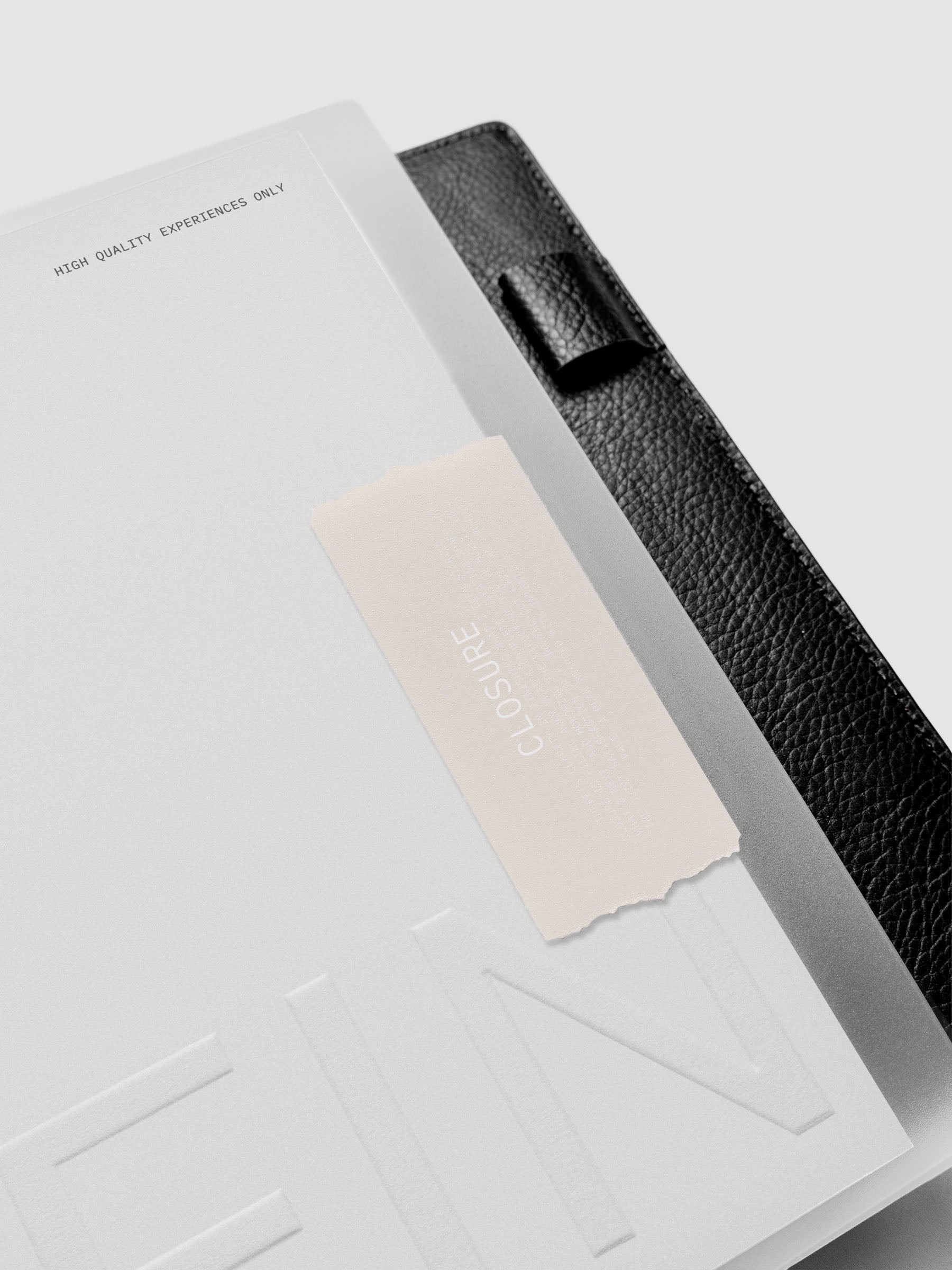 Close up of Closure Planner Dashboard + Cover Set in size Half Letter shown discbound in a black leather folio cover displaying tape inspired design and FIN text on dashboard.