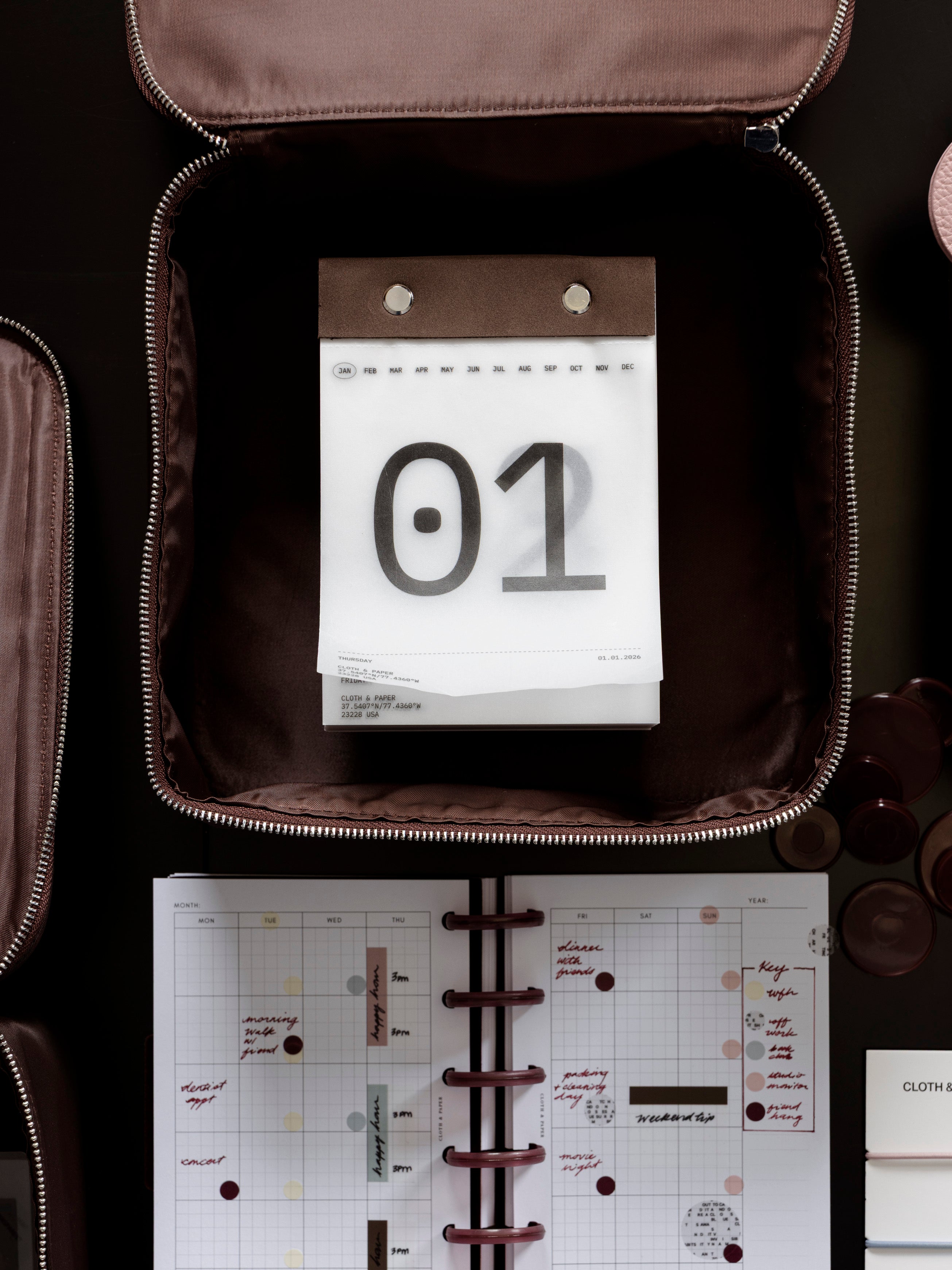 2026 Today Tear Off Pad nested inside of a organizing bag on a table with a filled out planner.