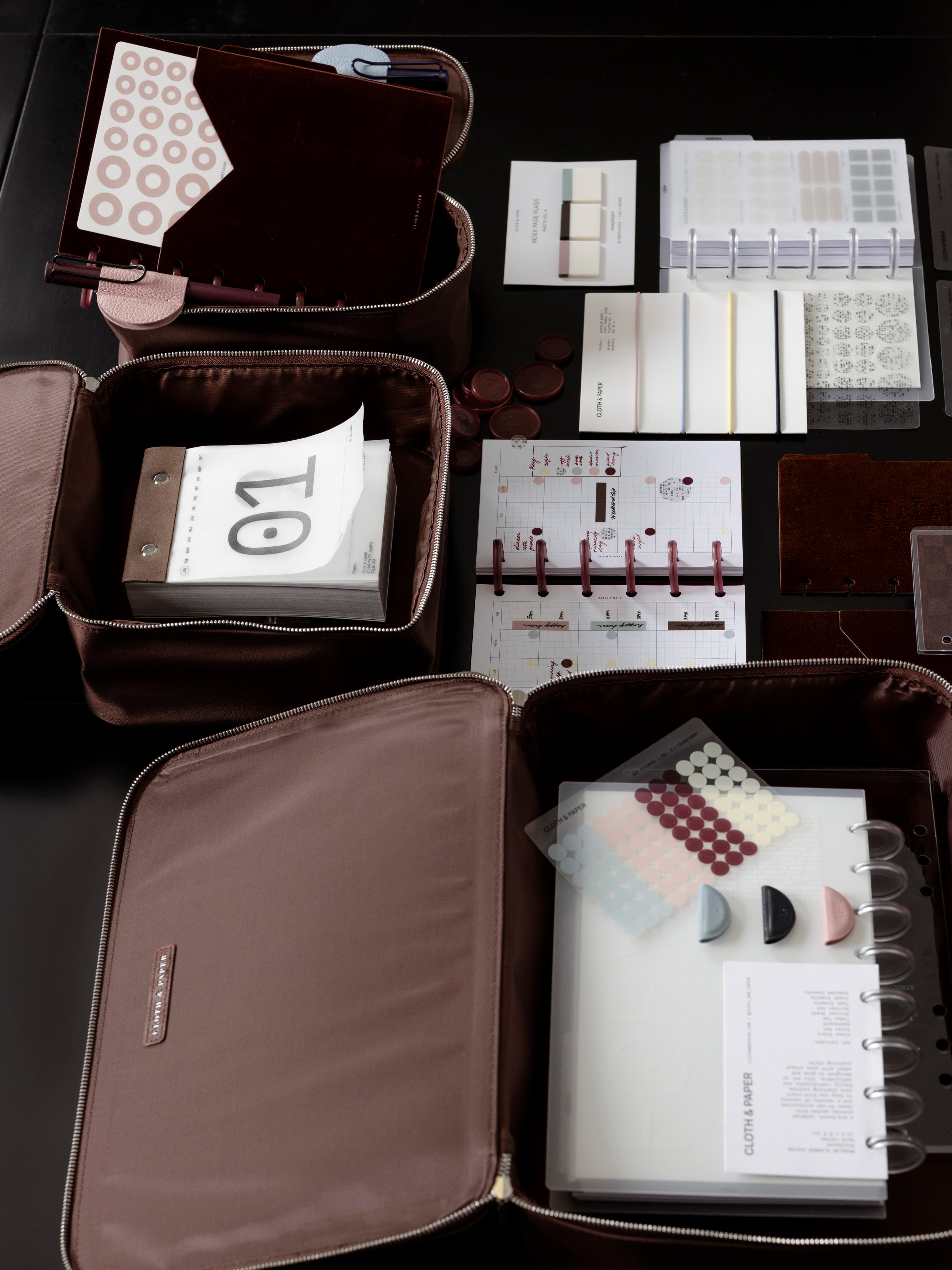 Set of three nesting packing cubes in small, medium, and large with various Cloth & Paper products featured inside.