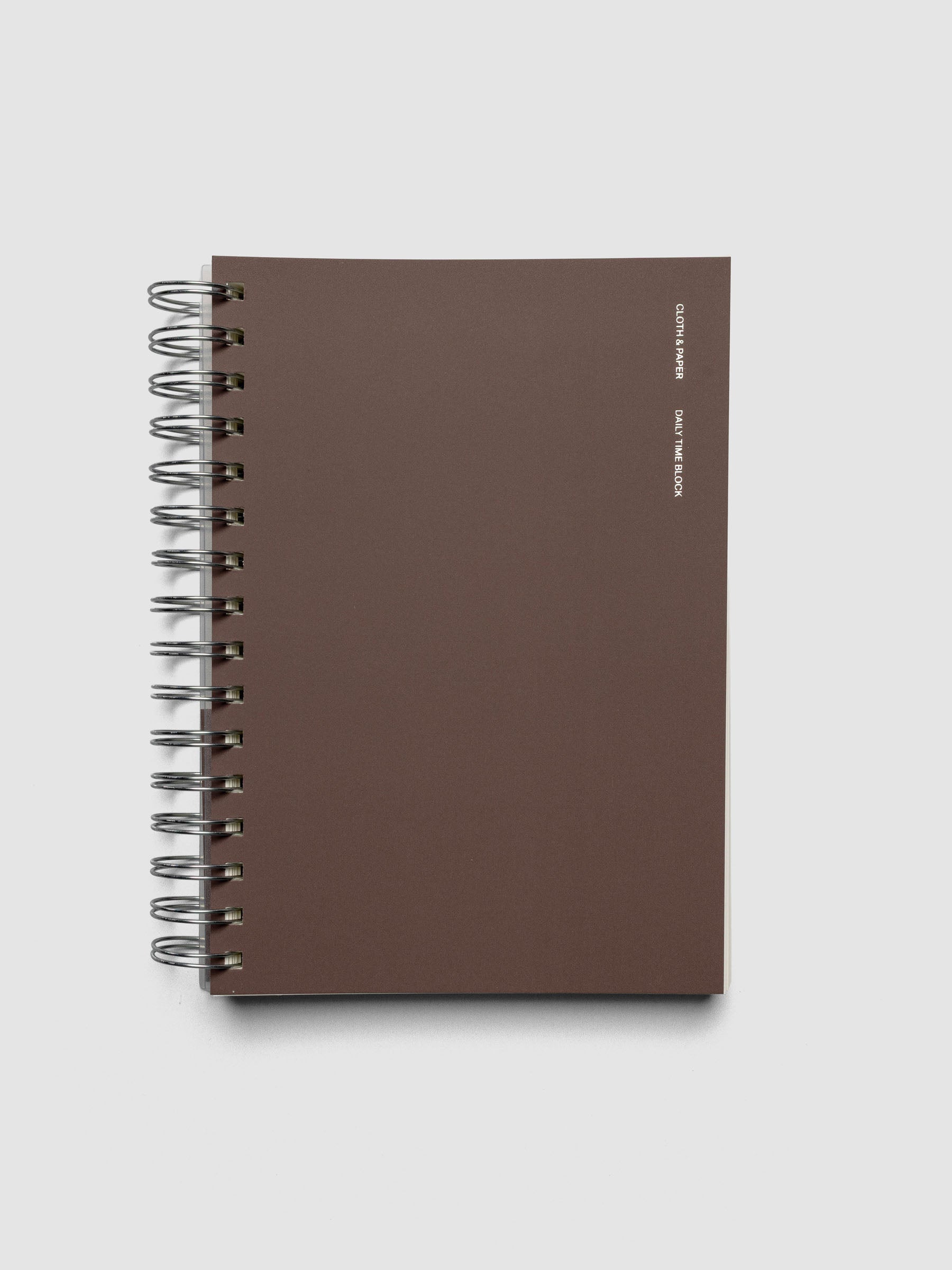 Spiral Notebook in size A5 and color Espresso brown with Daily Time Block interior pages shown closed.
