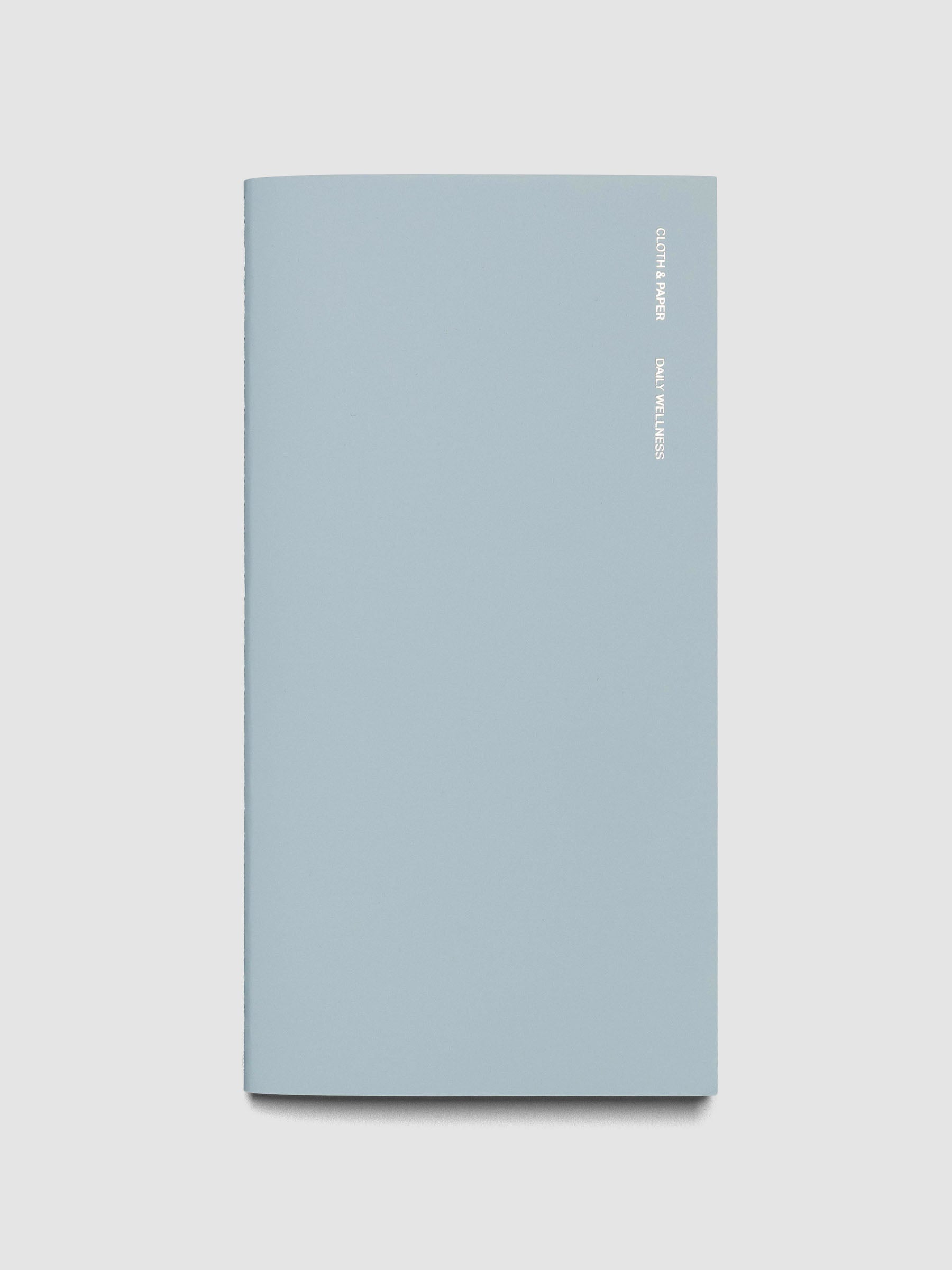 Travel Notebook in size A5 Slim in color Smoked Salt with Daily Wellness pages shown closed.
