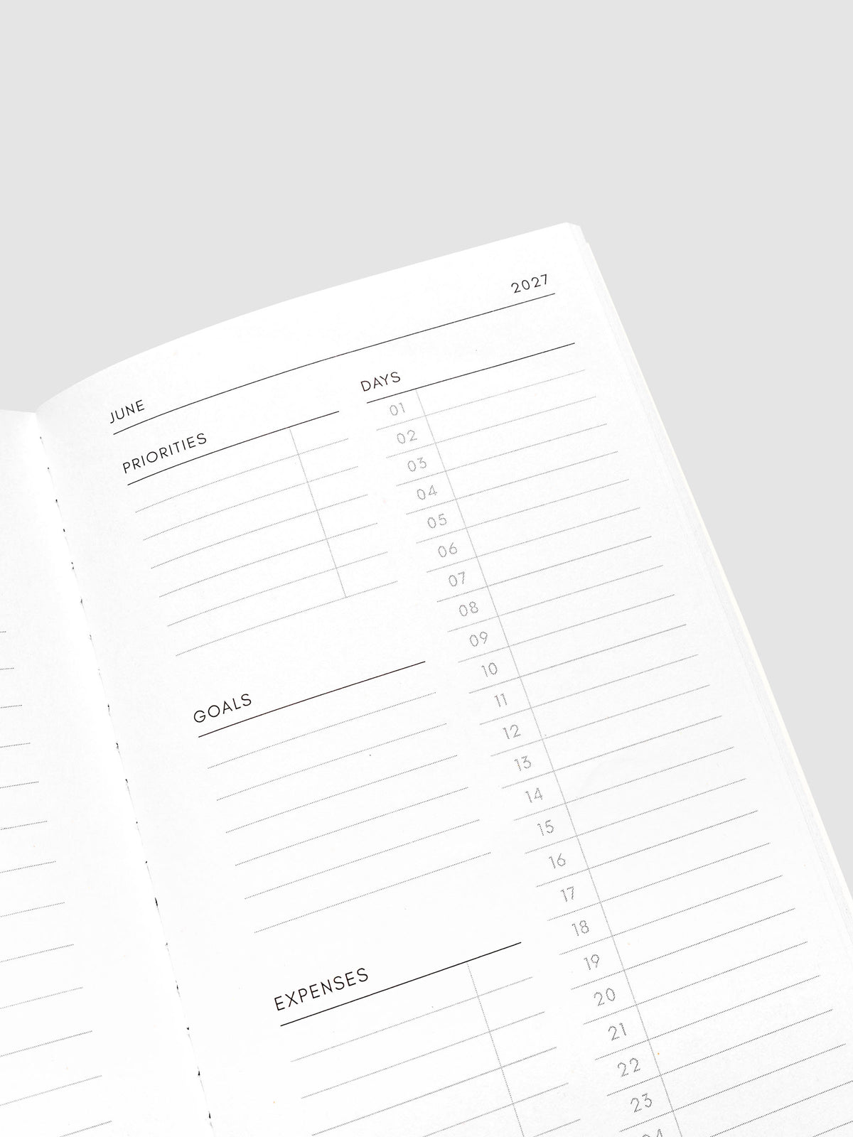 Close-up of the top of the right page of the 2027 Dated Travel Notebook Monthly in Pocket Plus size, showing the days, priorities, goals, and expenses sections