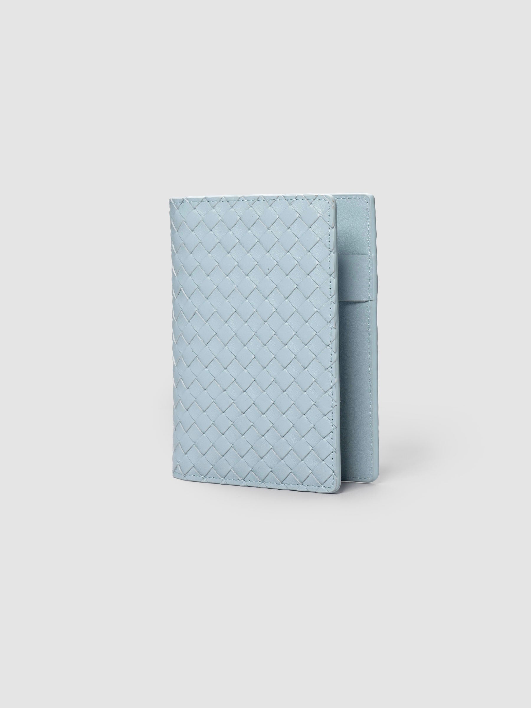 Blue woven leather planner cover shown standing at an angle.