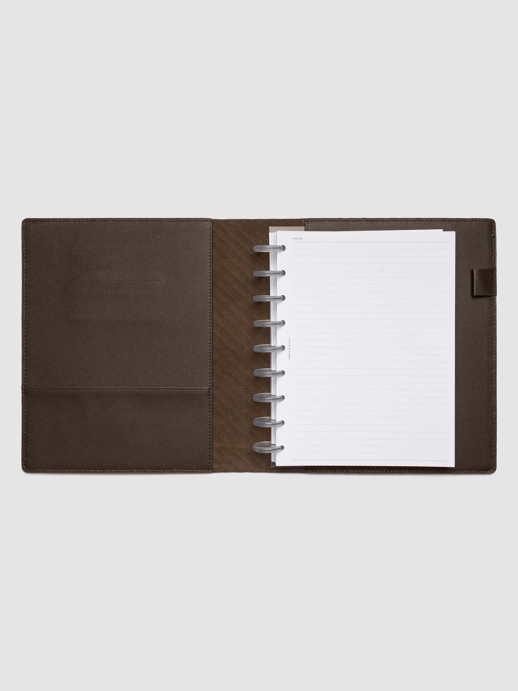 Dark brown leather planner folio with an HP Classic discbound planner inside.