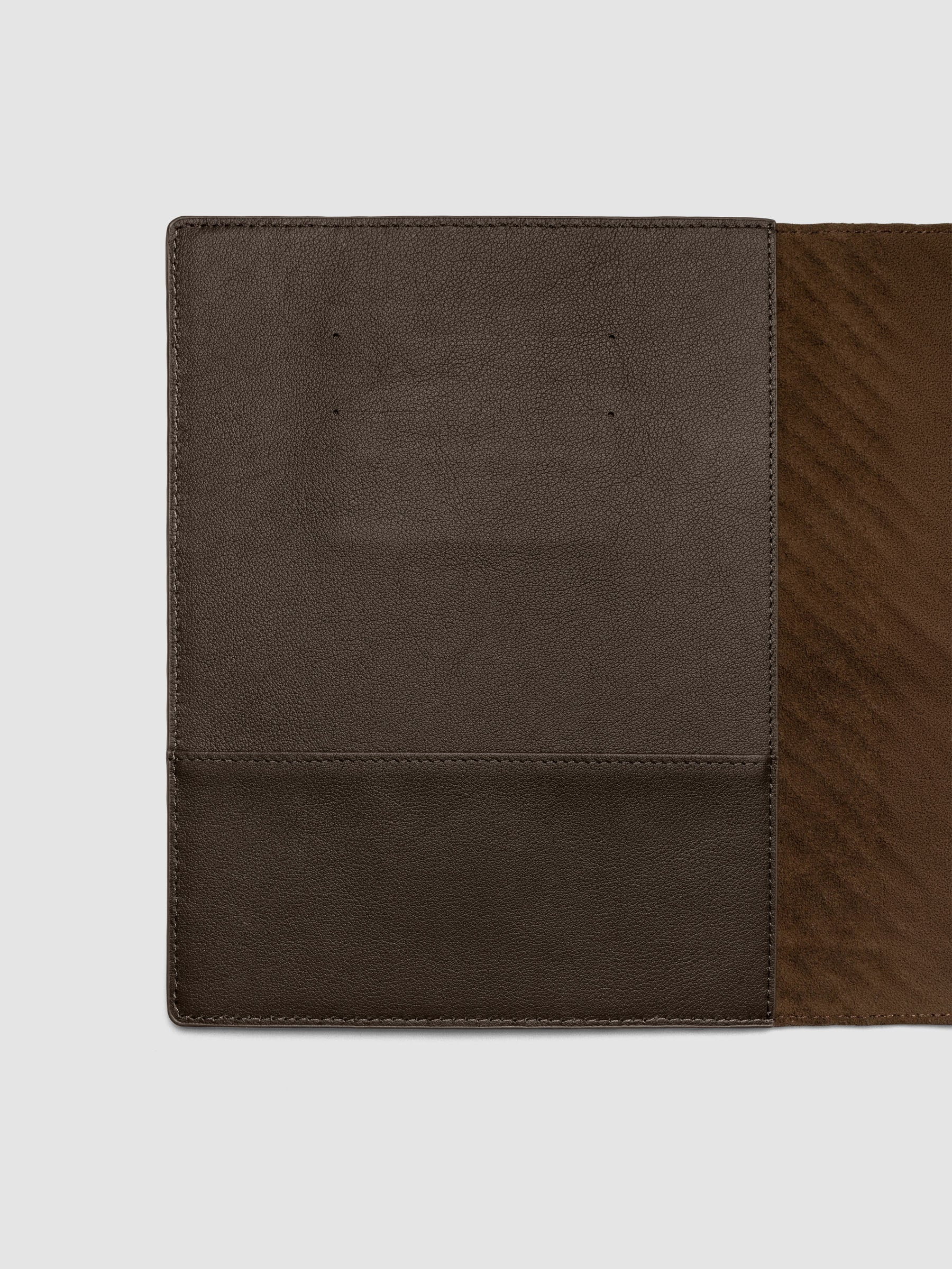 Interior left hand side of a dark brown leather planner folio cover.