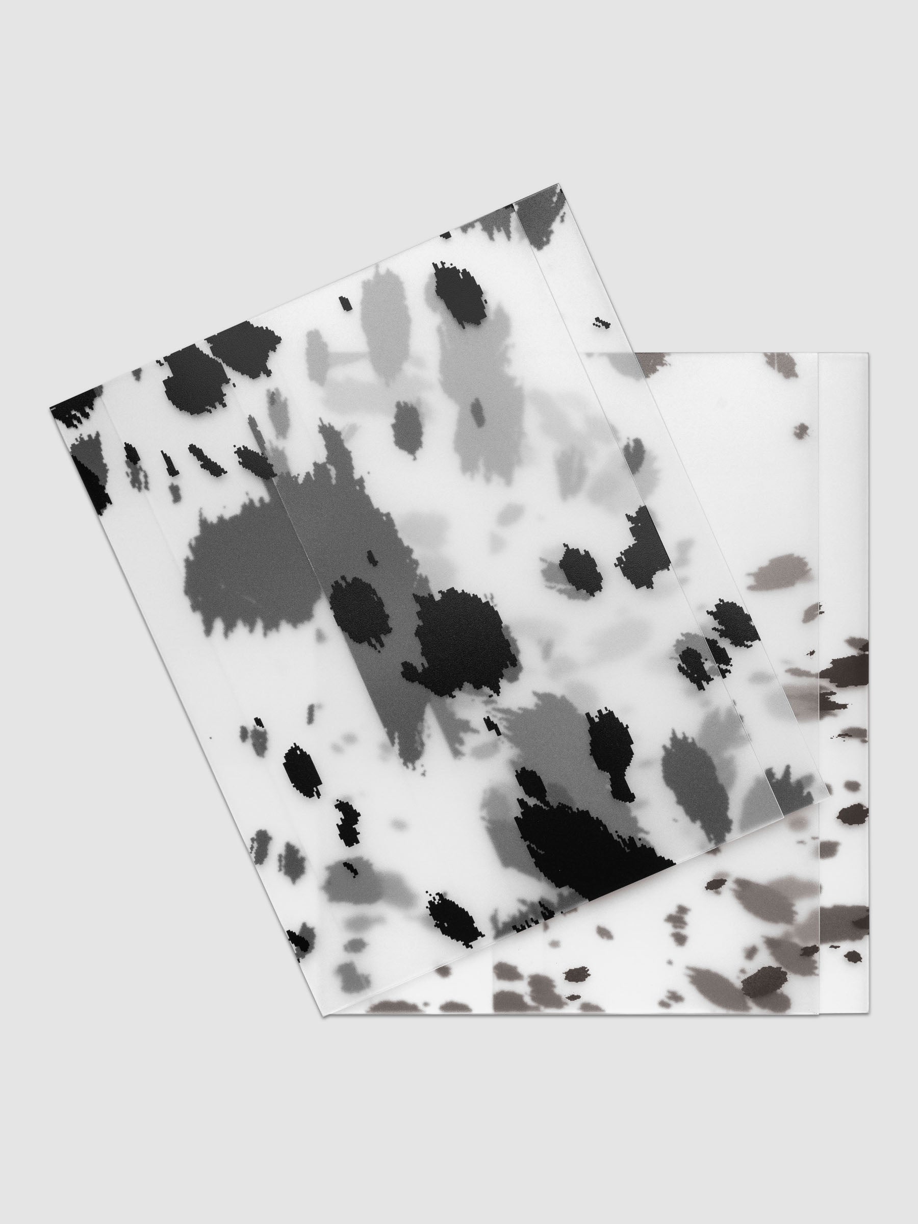 Two HP Classic frosted plastic notebook covers with dalmatian animal print pattern stacked and offset, shown in black and brown