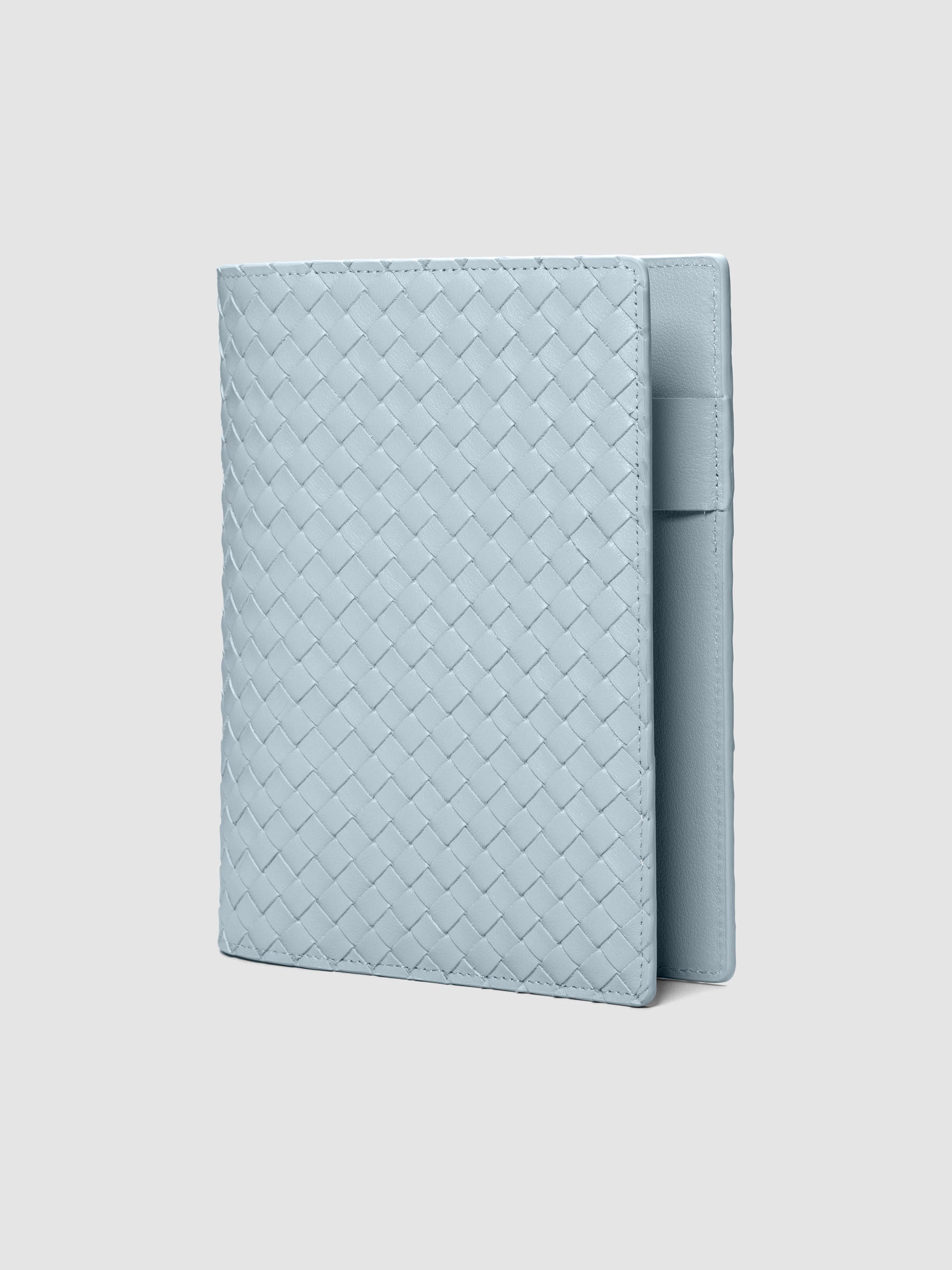 Blue woven leather planner cover shown standing at an angle.