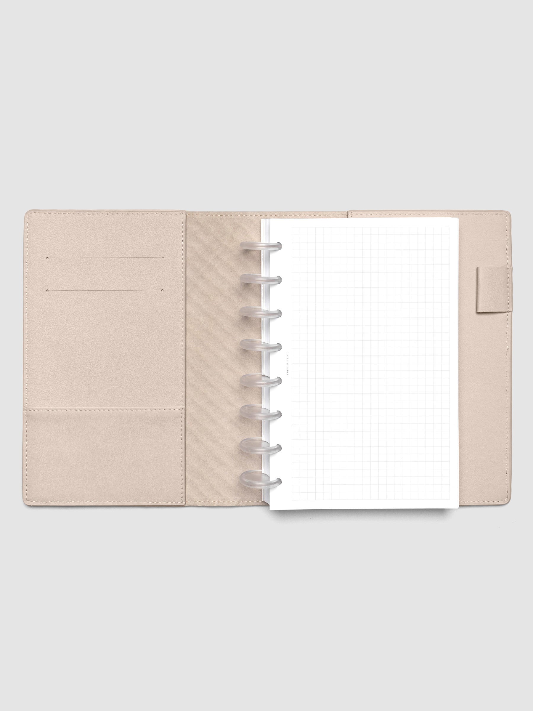 Beige leather planner folio with an Half Letter discbound planner inside.