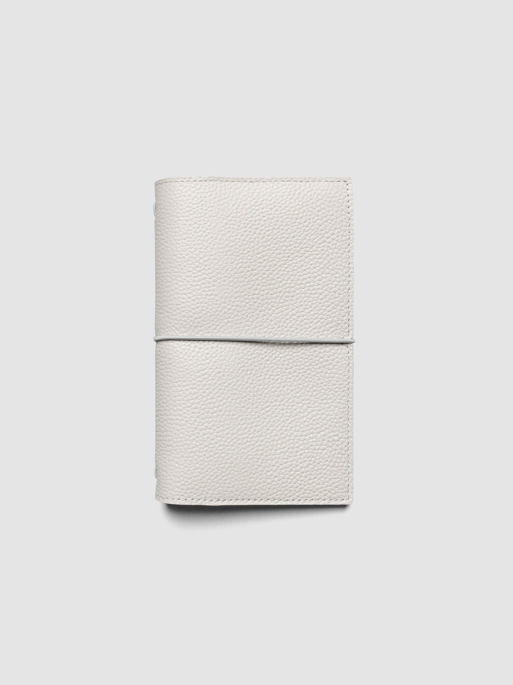 Light grey genuine leather travel notebook cover shown in size Pocket Plus.
