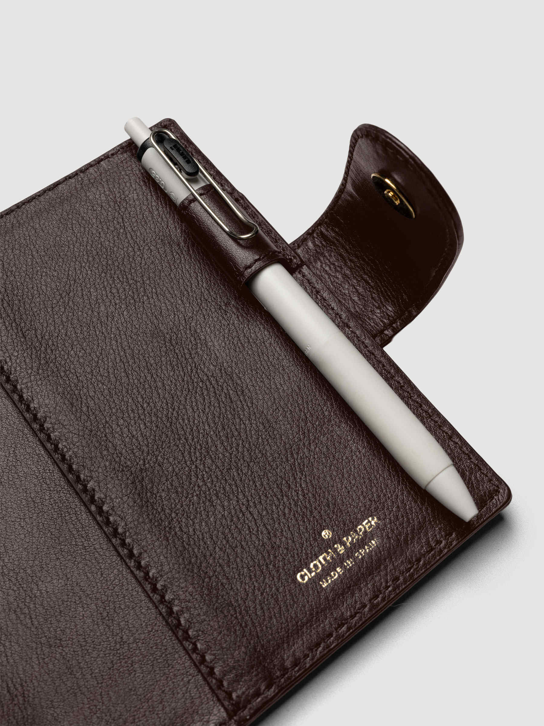 Heirloom Ring Cover Genuine Leather Pocket 6-Ring Punch in dark brown, detail view of interior pen loop, large pocket, and closure with pen in pen loop