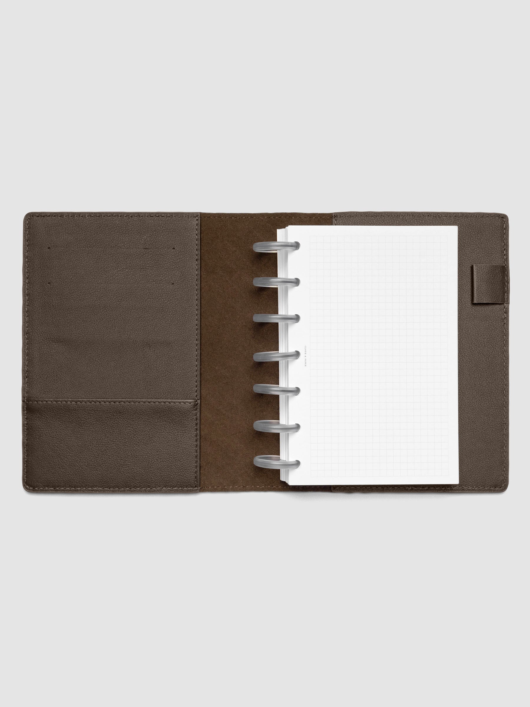 Dark brown leather planner folio with an HP Mini discbound planner inside.