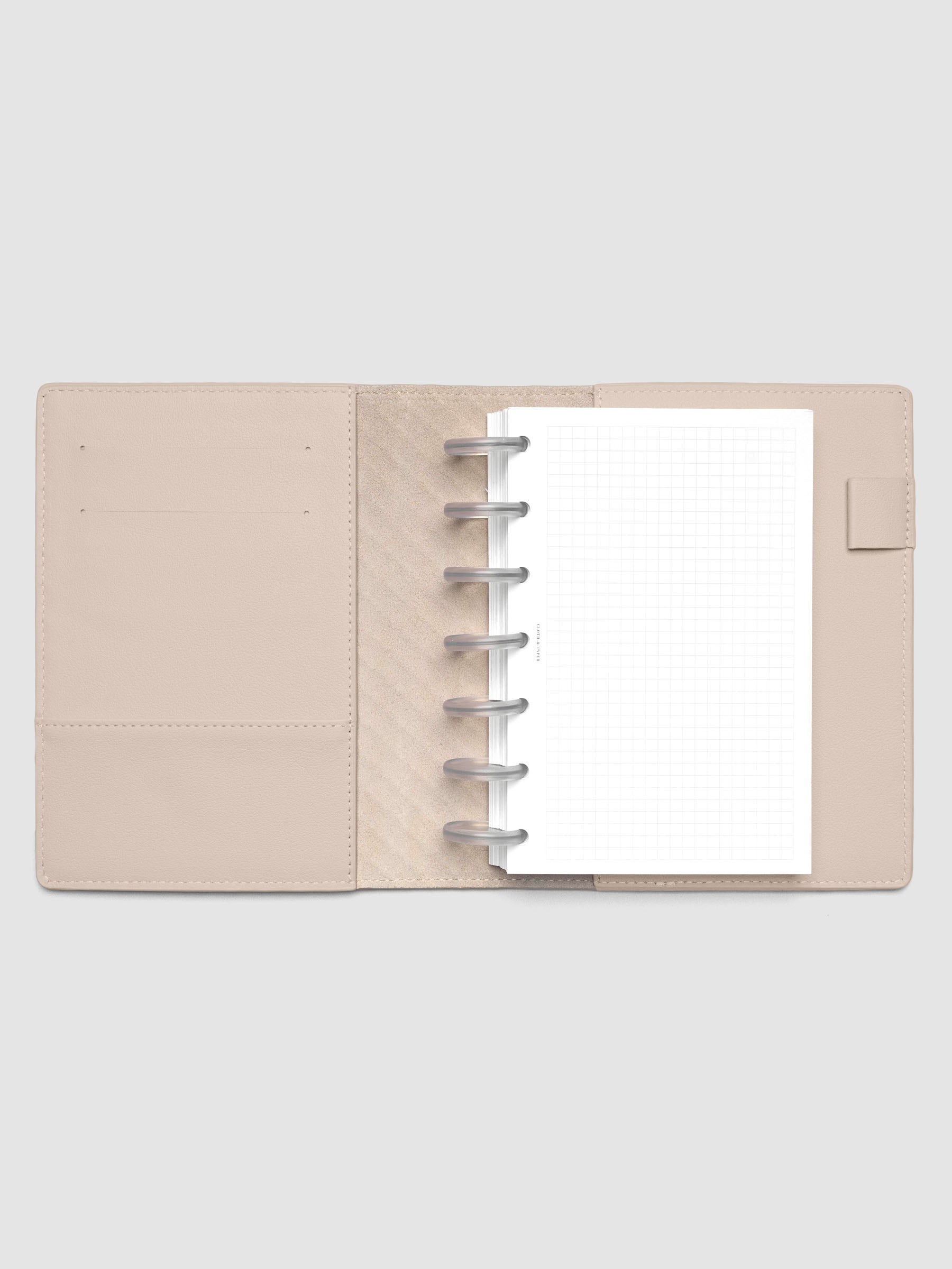 Beige leather planner folio with an HP Mini discbound planner inside.
