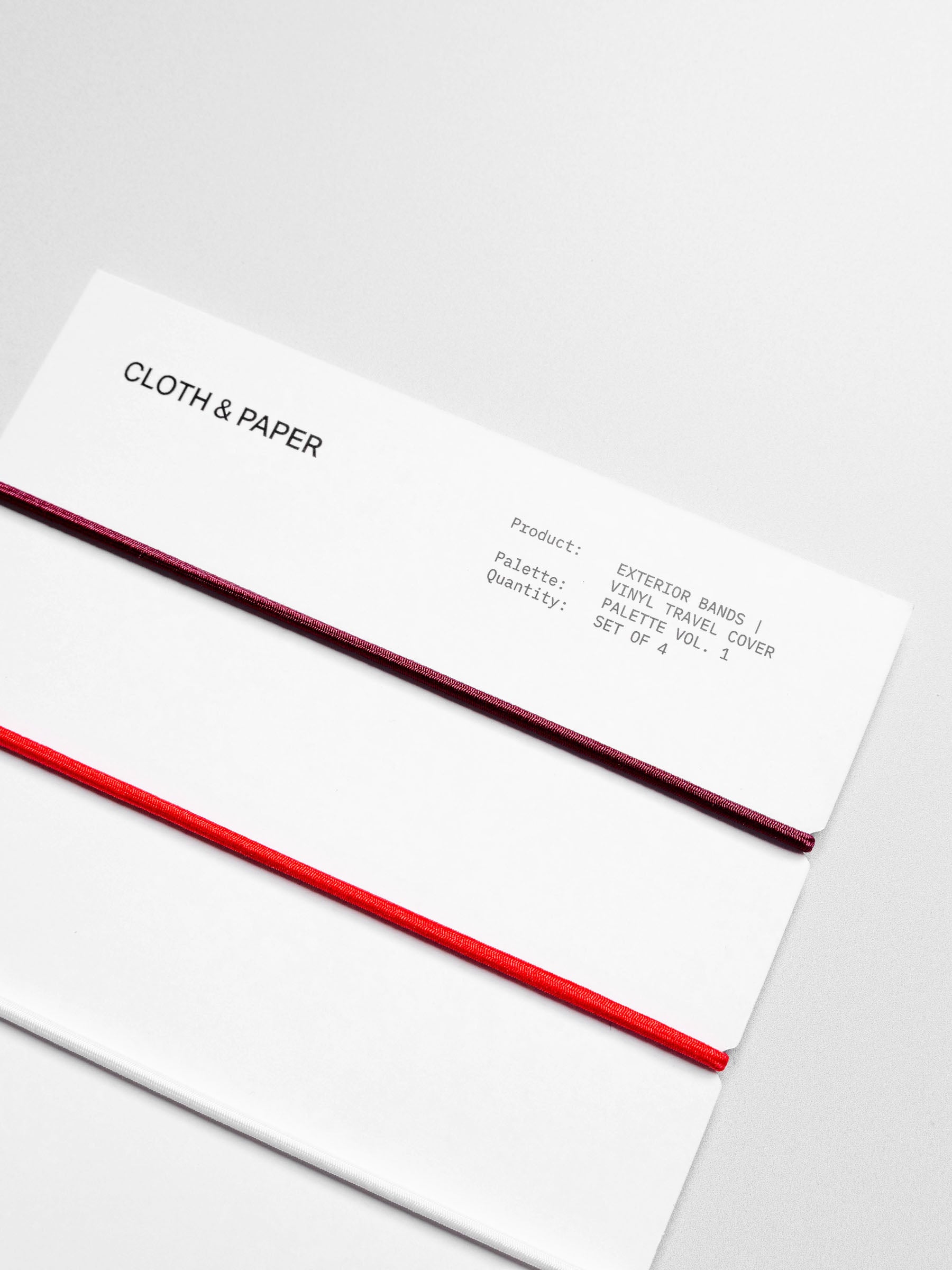 Closeup of travel bands displayed in their packaging on a neutral background.