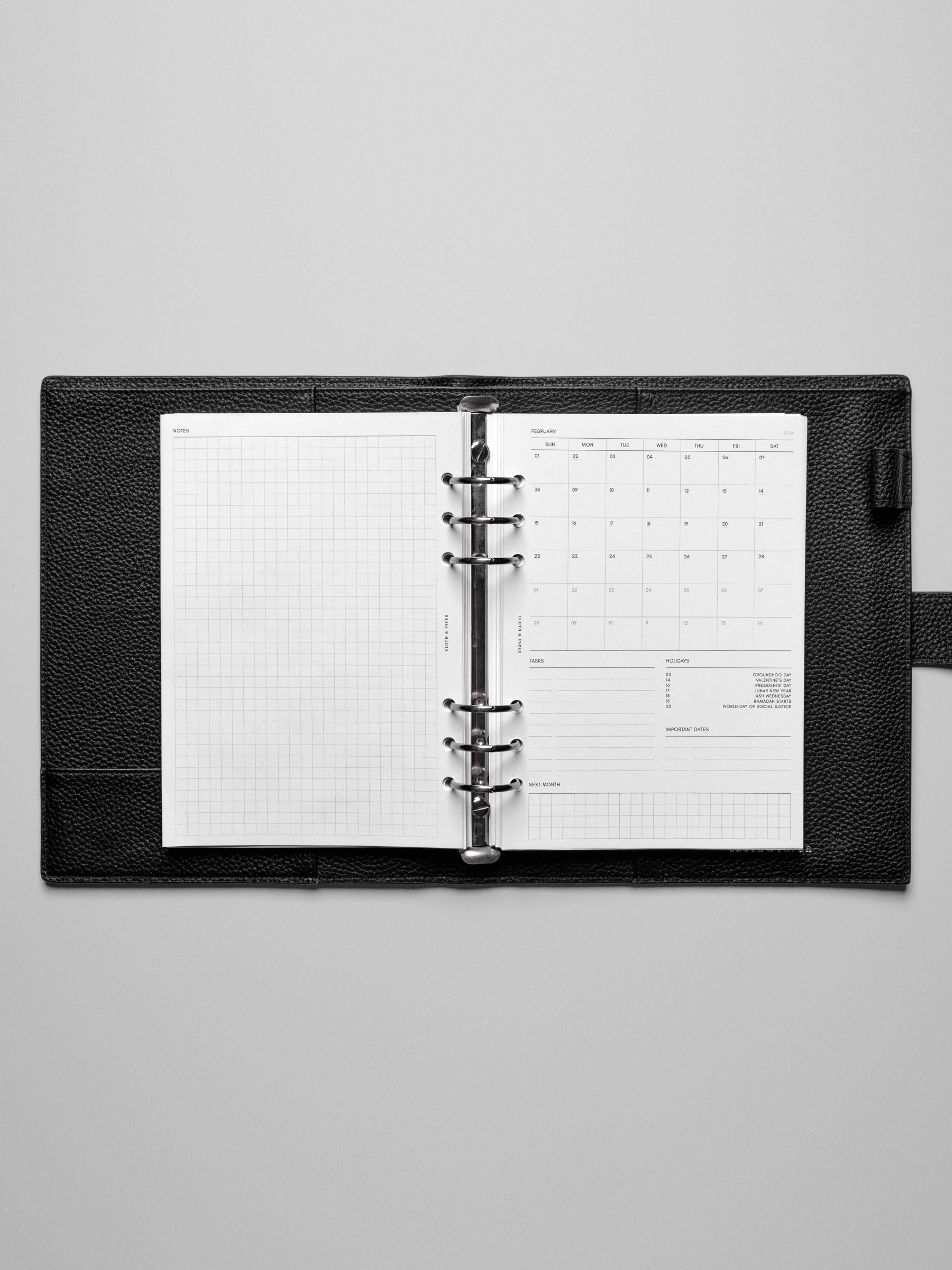 Image shows the Sunday Start 2026 Dated Monthly Admin Planner Inserts in a black leather ring-bound planner.