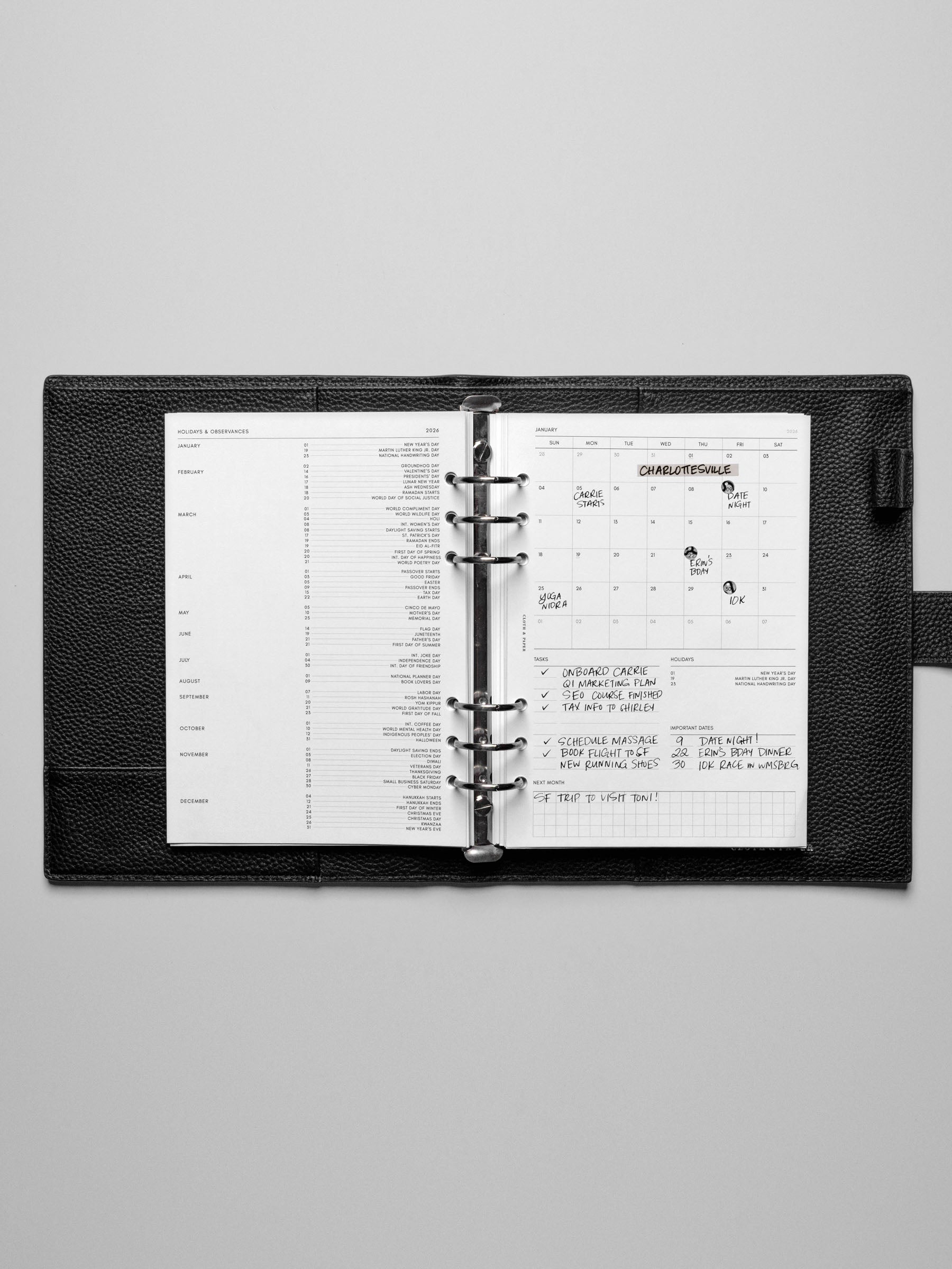 Image shows the Sunday Start 2026 Dated Monthly Admin Planner Inserts in a black leather ring-bound planner.