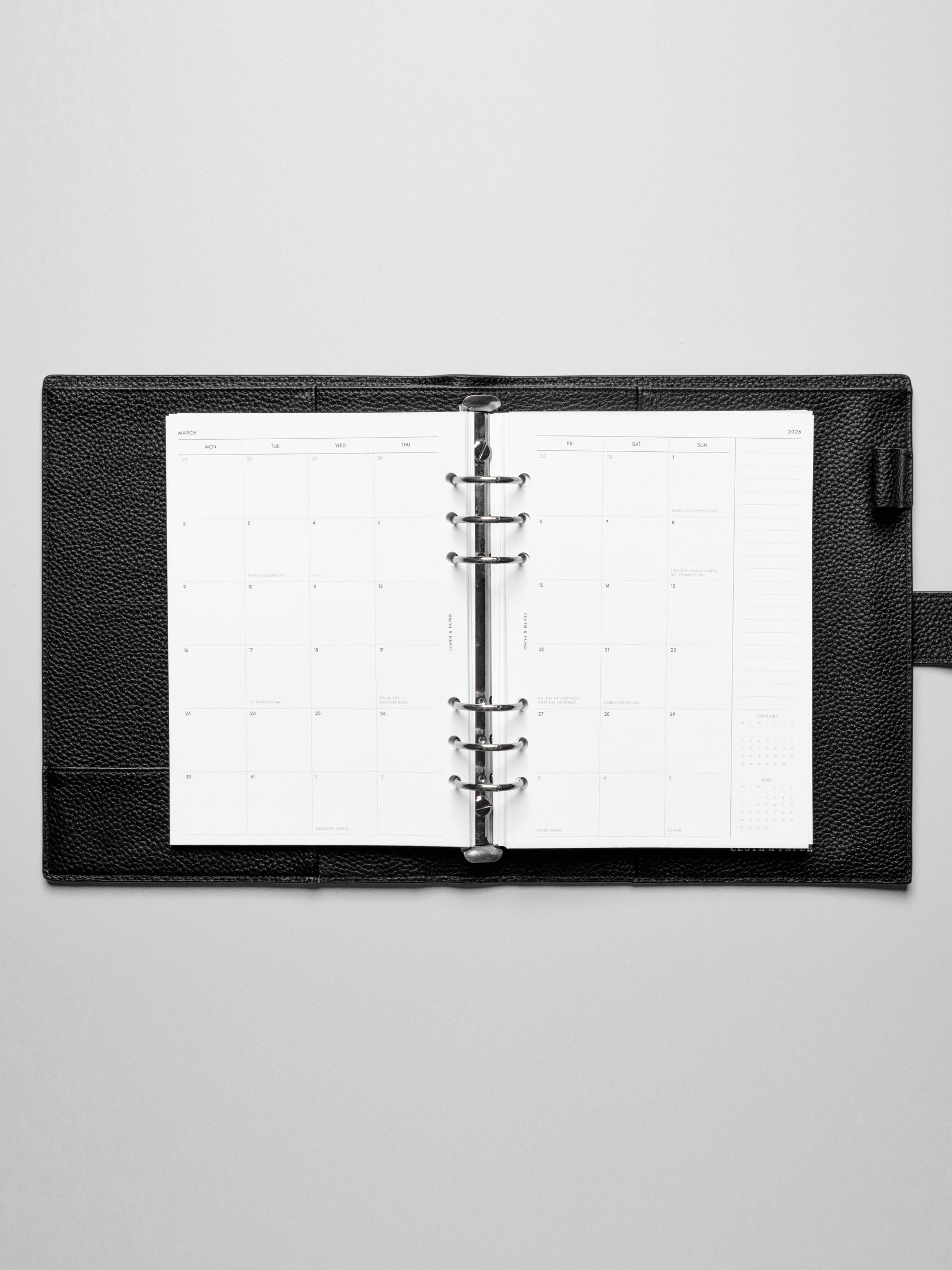 Image shows the Monday Start 2026 Dated Monthly Planner Inserts used in a black leather A5 ring-bound planner.
