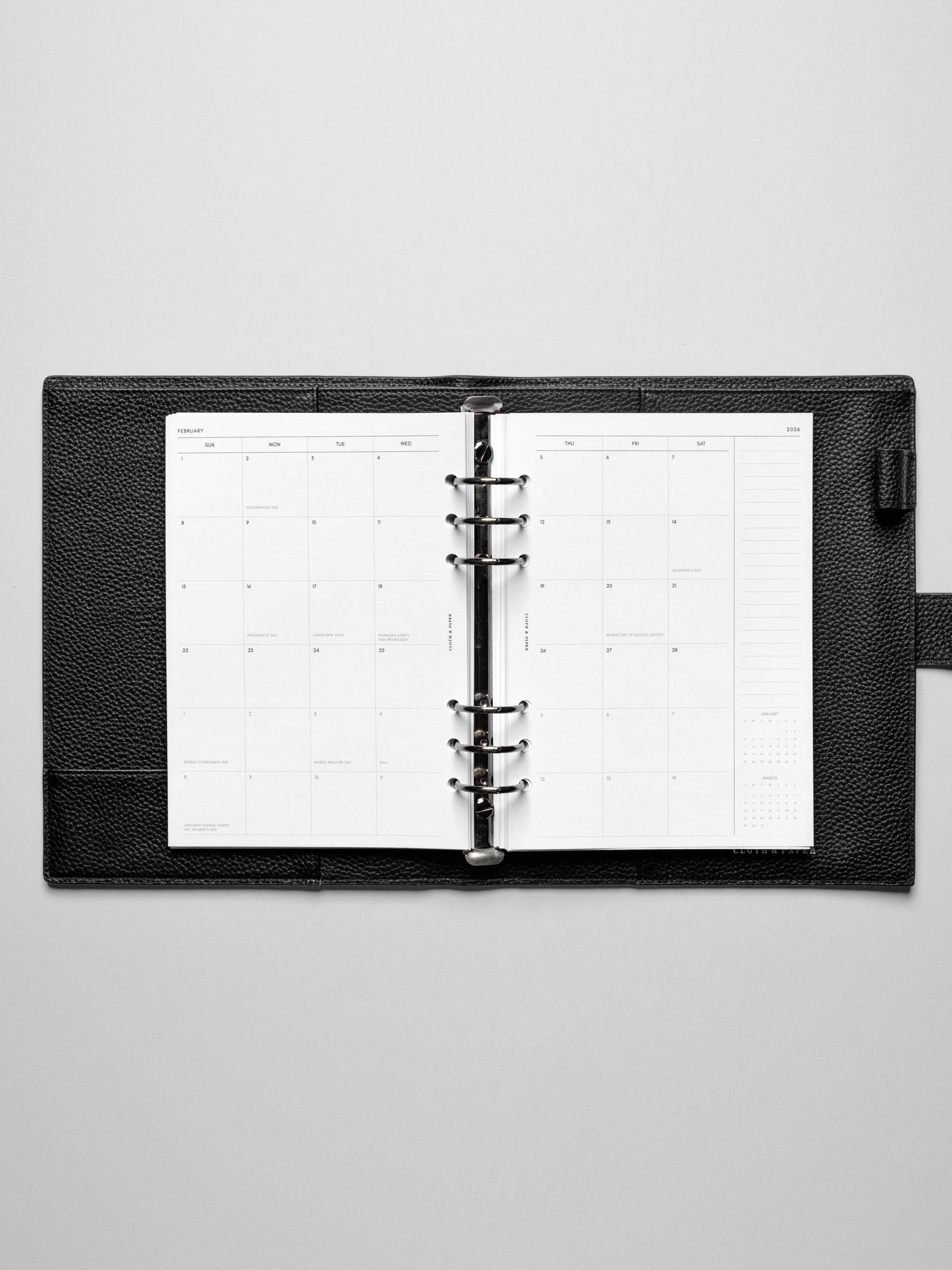 Image shows the Sunday Start 2026 Dated Monthly Planner Inserts in a black leather ring-bound planner.
