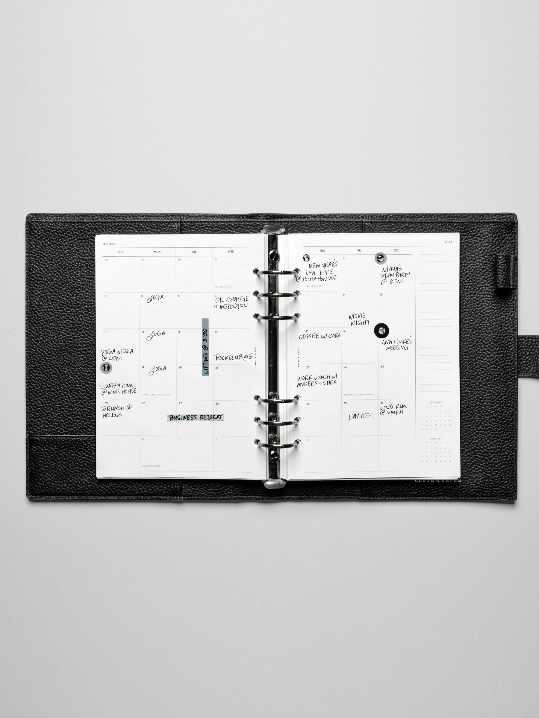 Image shows the Sunday Start 2026 Dated Monthly Planner Inserts in a black leather ring-bound planner. Stickers and sticky notes are used to highlight notes.