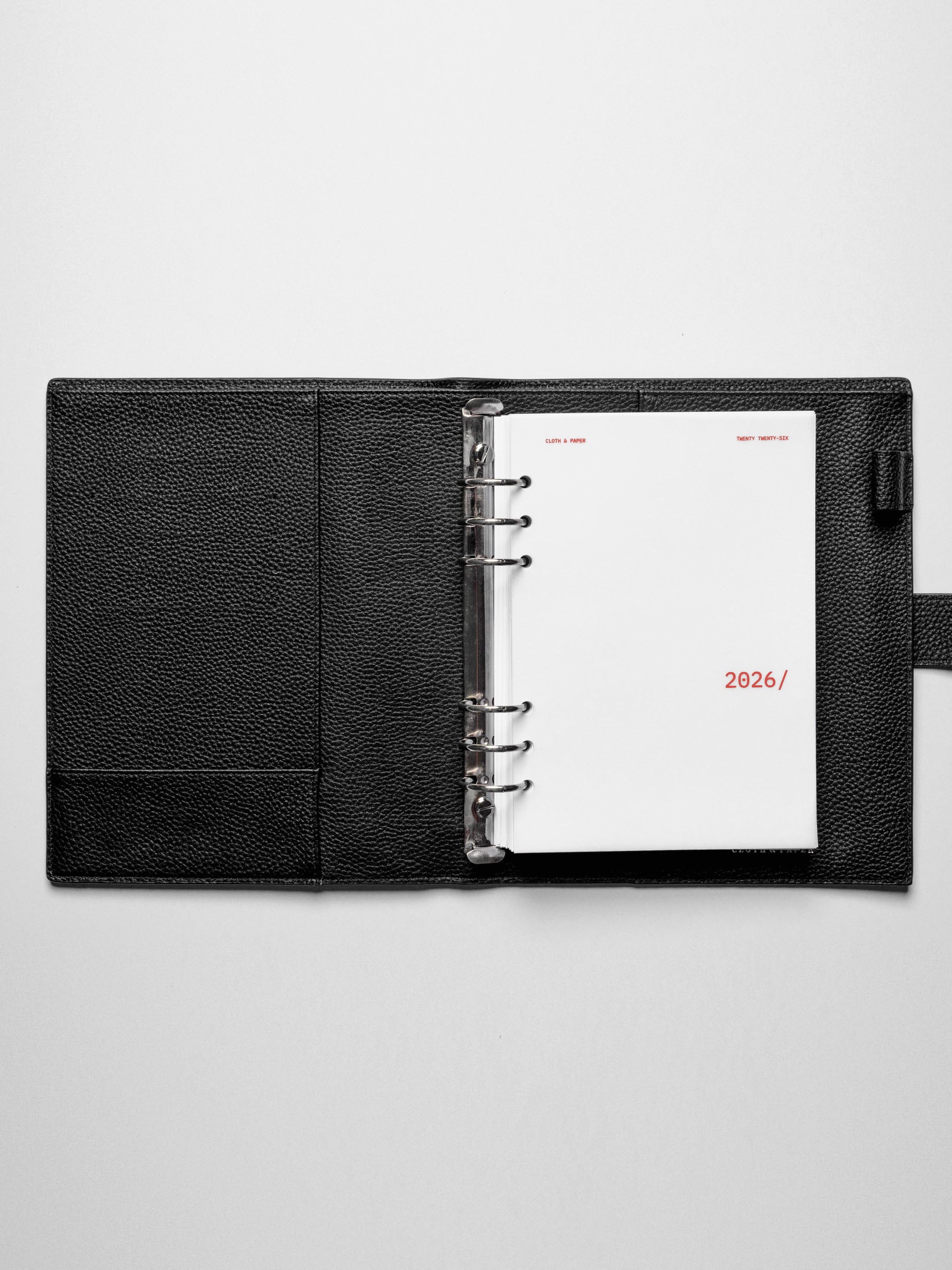 Image shows the front cover used in a black A5 ring-bound leather folio.