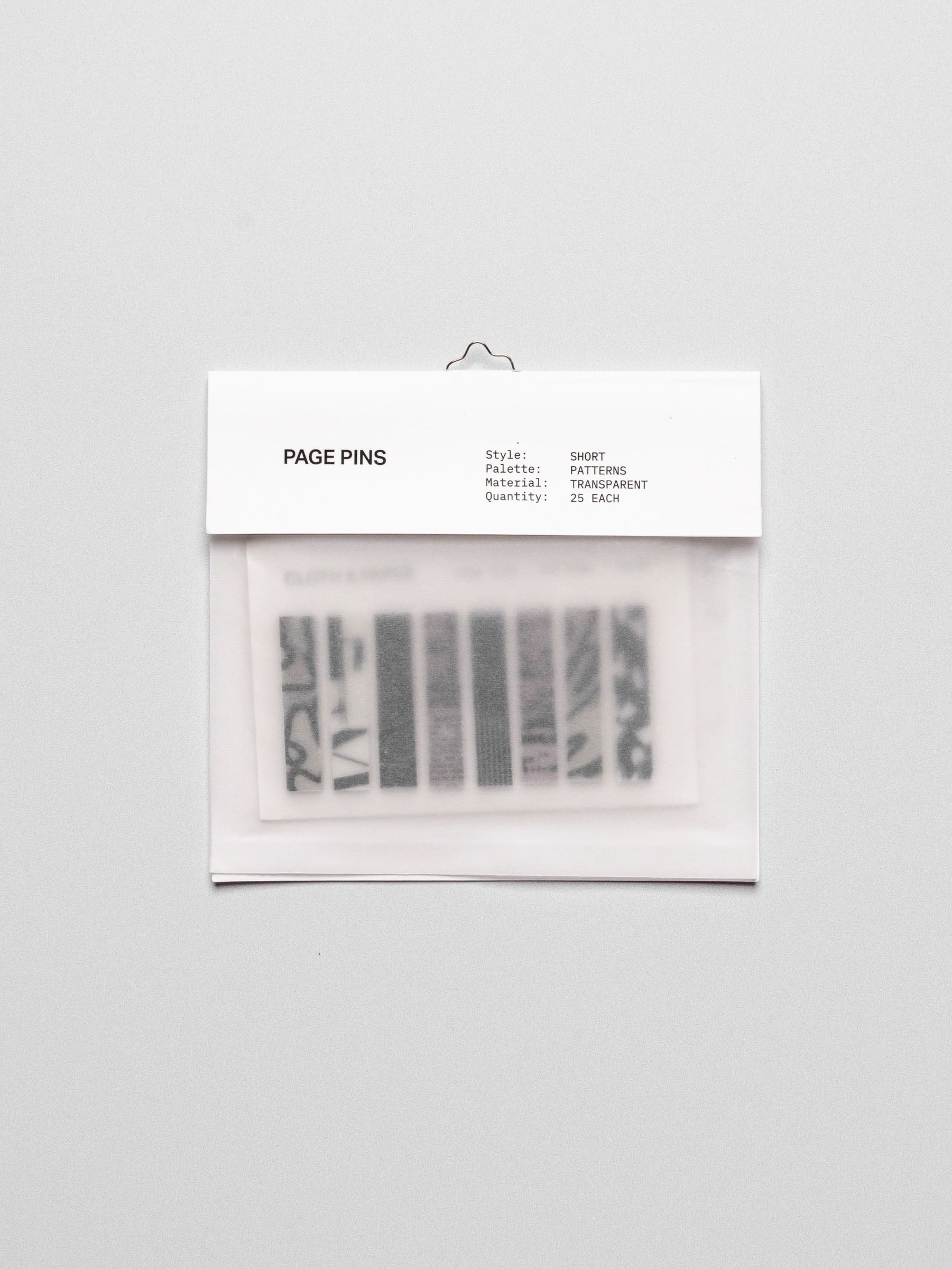 Short page pins displayed in their packaging on a neutral background.