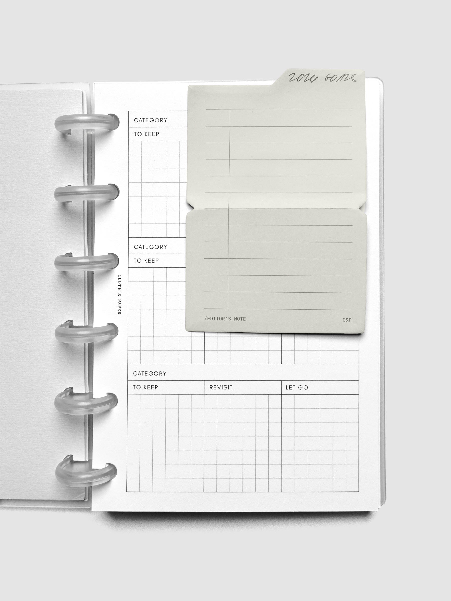 Task Folding Sticky Notes in use on a planner insert with handwritten notes.