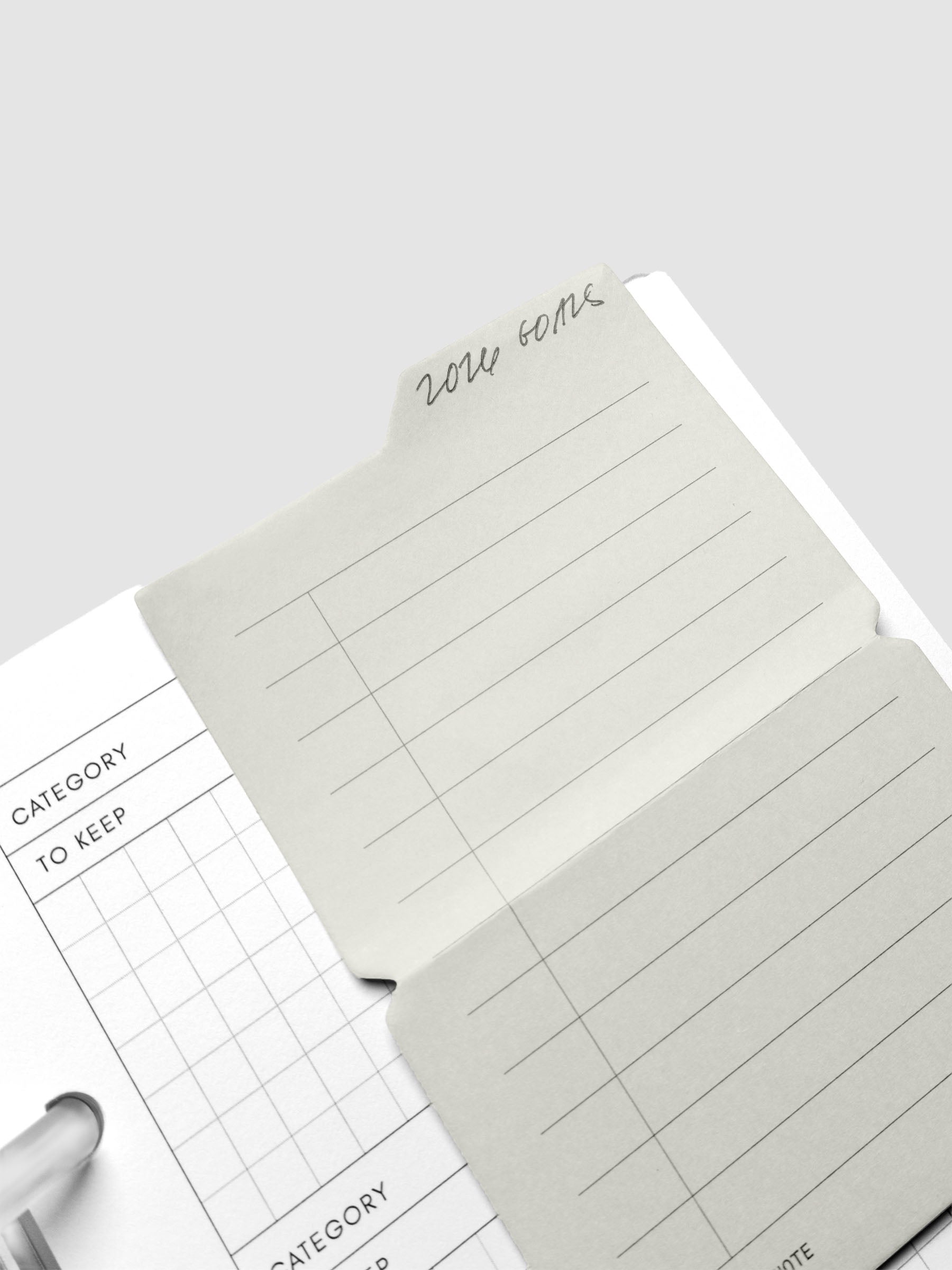 Task Folding Sticky Notes in use on a planner insert with handwritten notes.