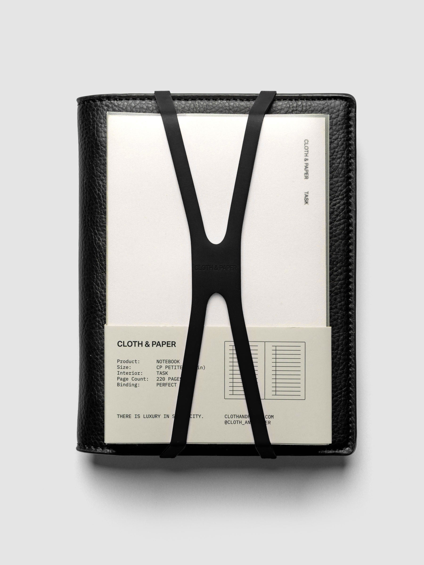 Small black planner closure band shown with a cp petite sized planner folio and perfect bound notebook.