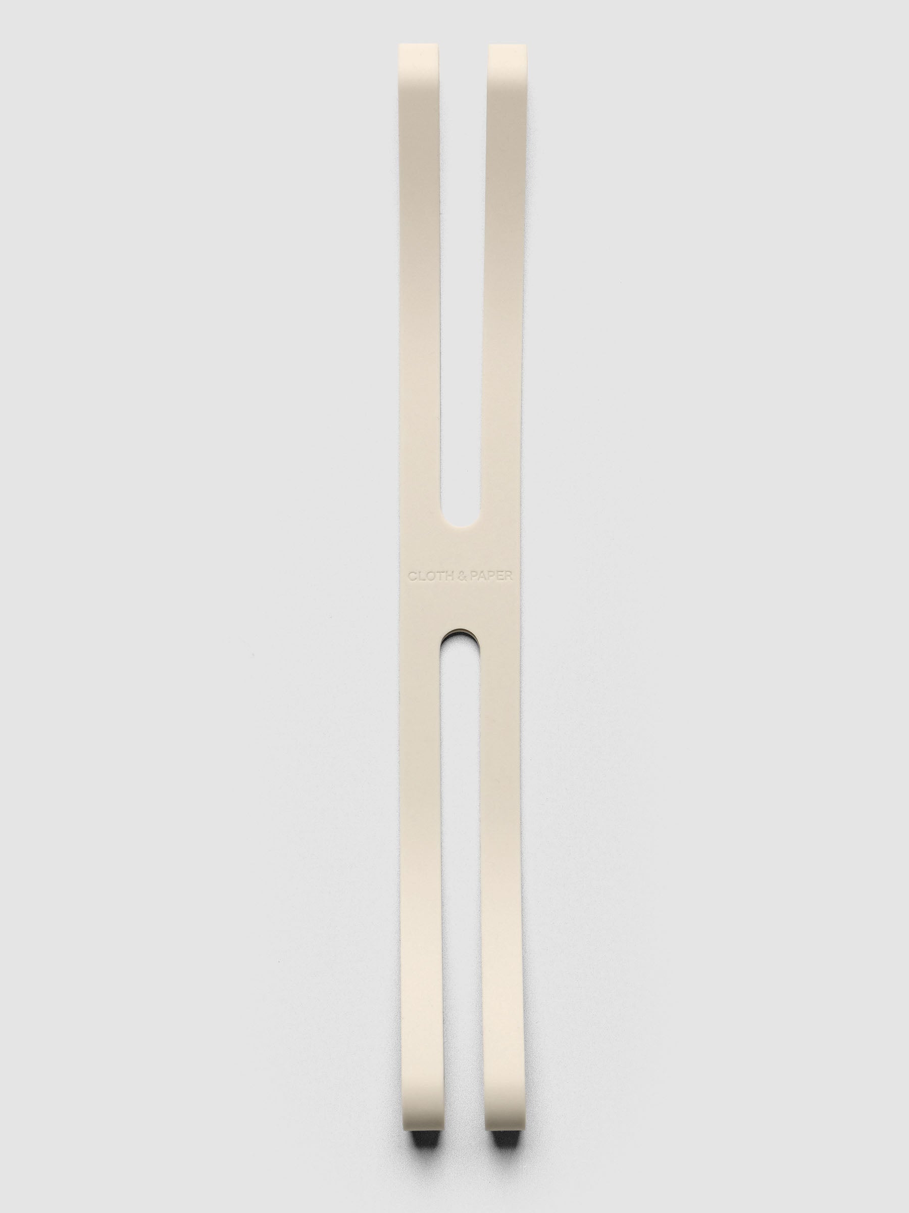 Large beige planner closure band on a neutral background.