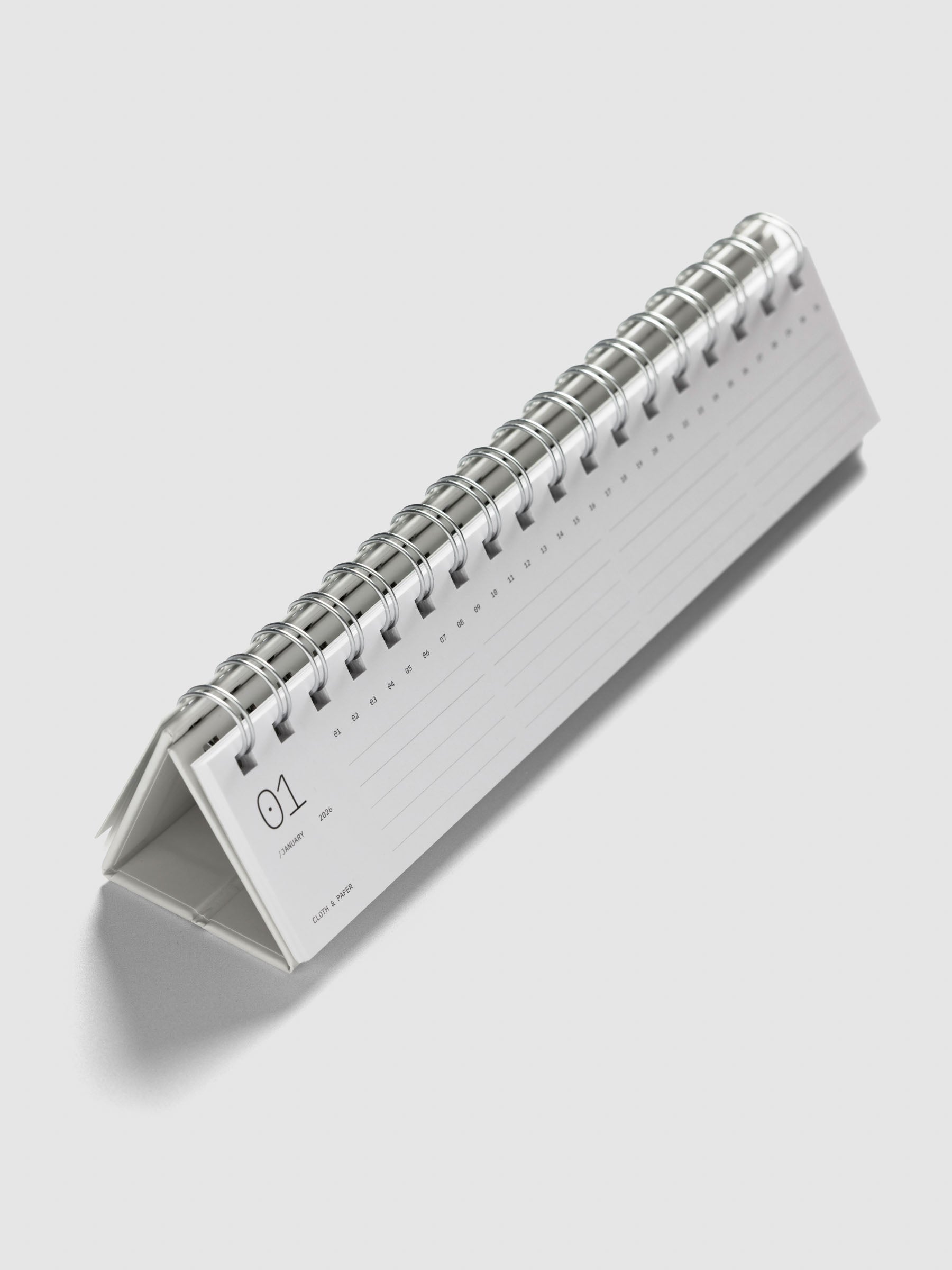 2026 Spiral Desk Calendar shown standing displaying a calendar page.