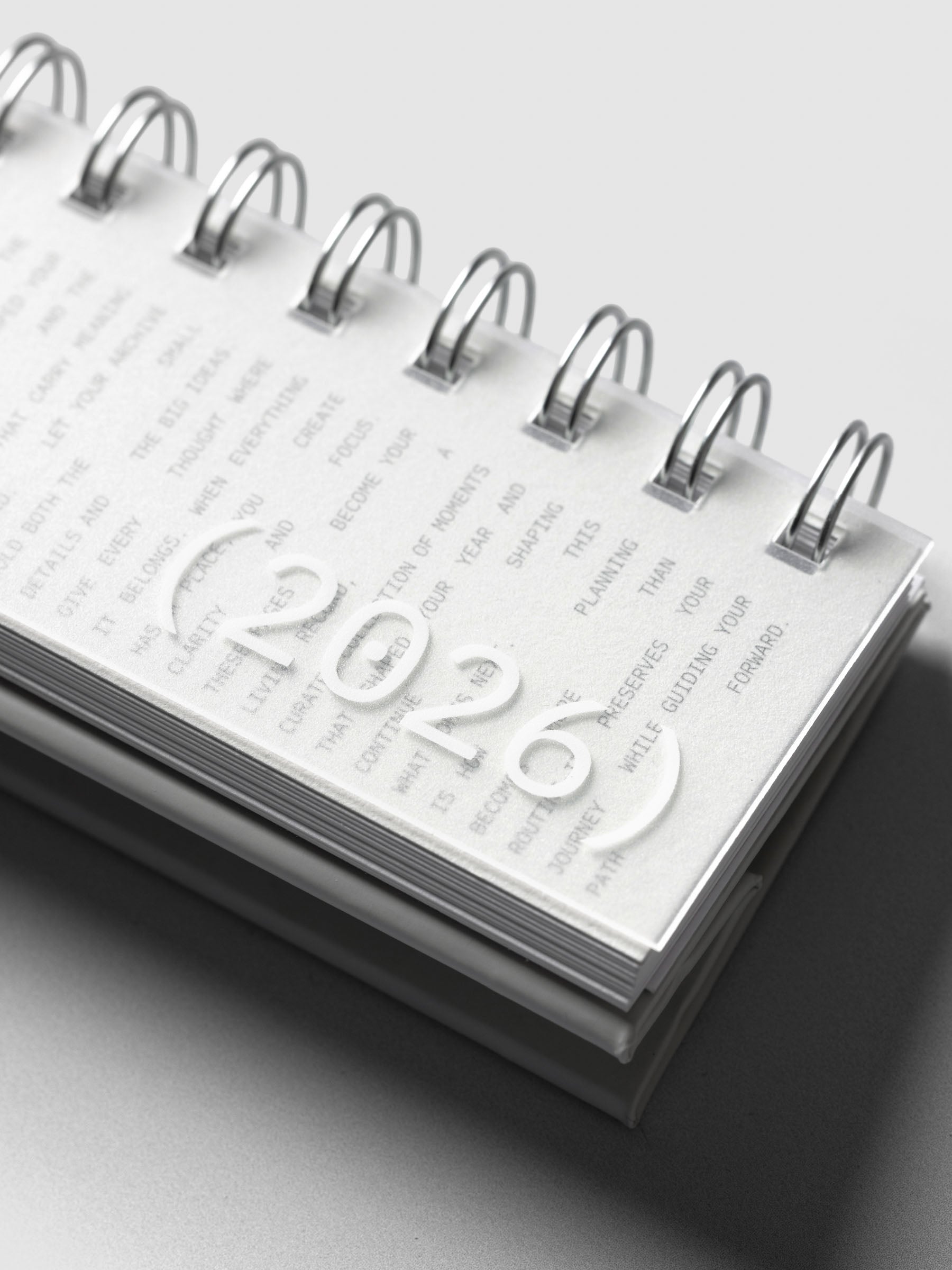 Close up of exterior of 2026 Spiral Desk Calendar displaying 2026 text.