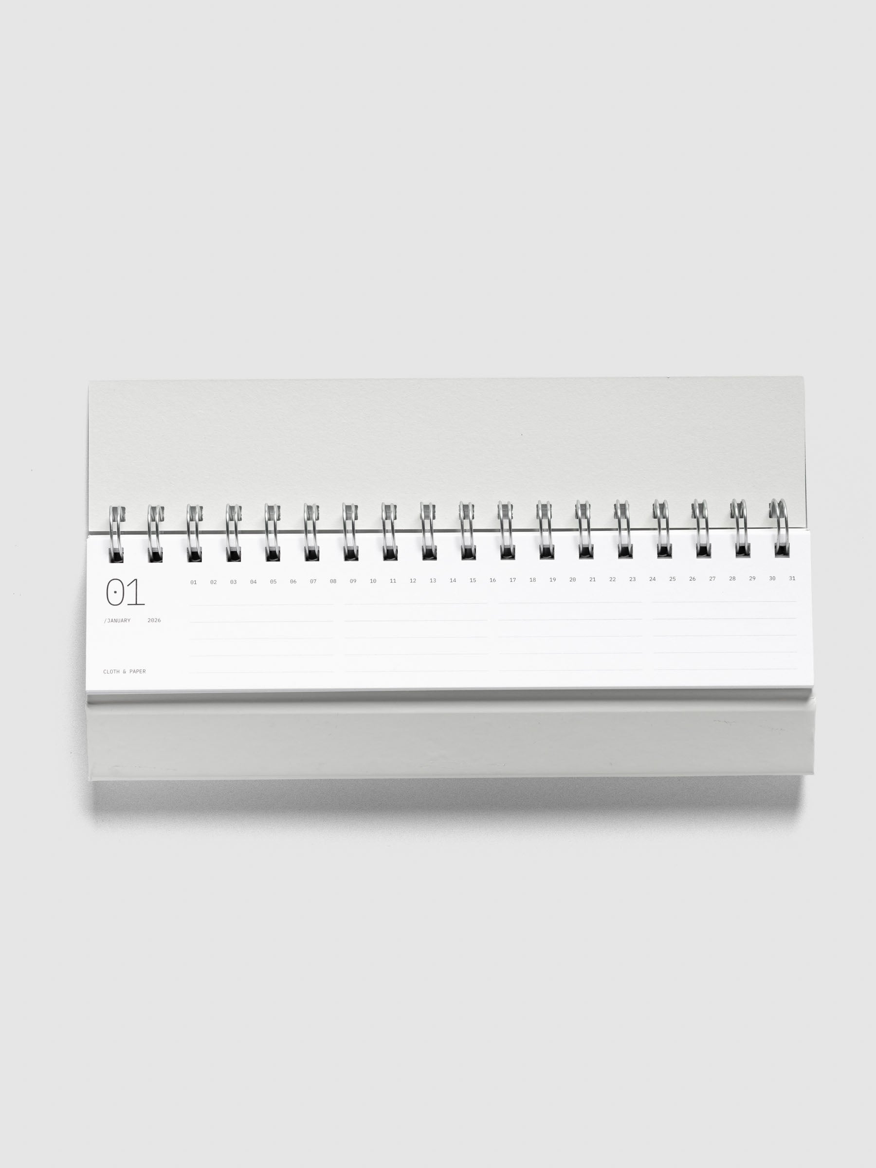 2026 Spiral Desk Calendar shown folded and flat, displaying a calendar page.