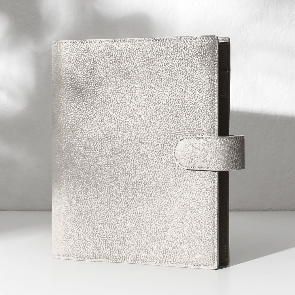 Ash  leather agenda displayed on an off-white background.