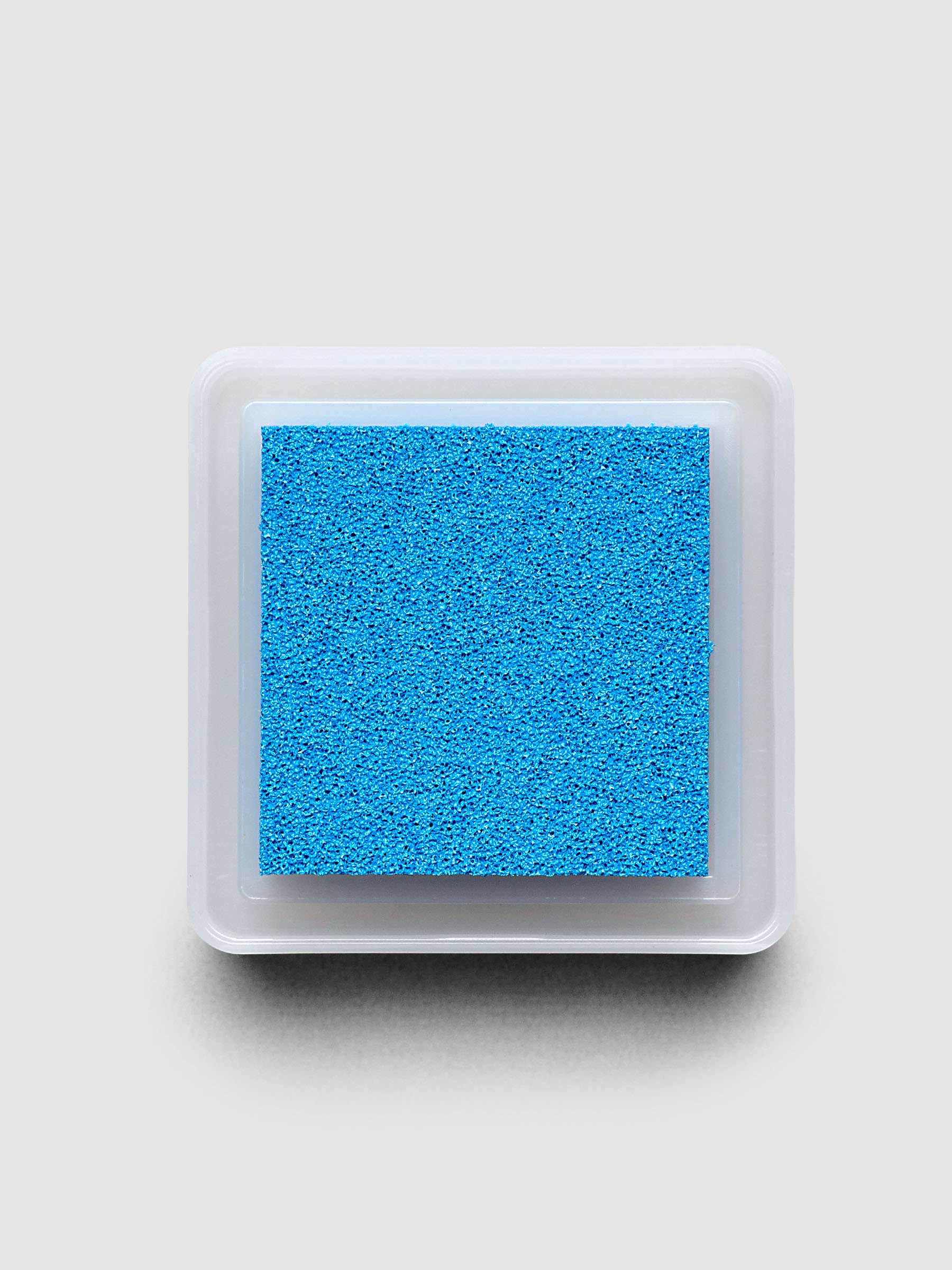 Artnic Stamp Ink Pad in cyan seen from the side with cover on