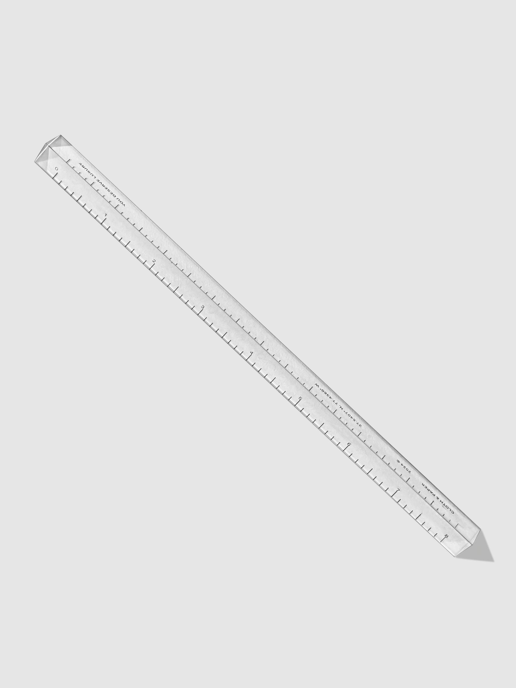 Acrylic Straight Edge Ruler, Cloth and Paper. Ruler displayed on a neutral background.
