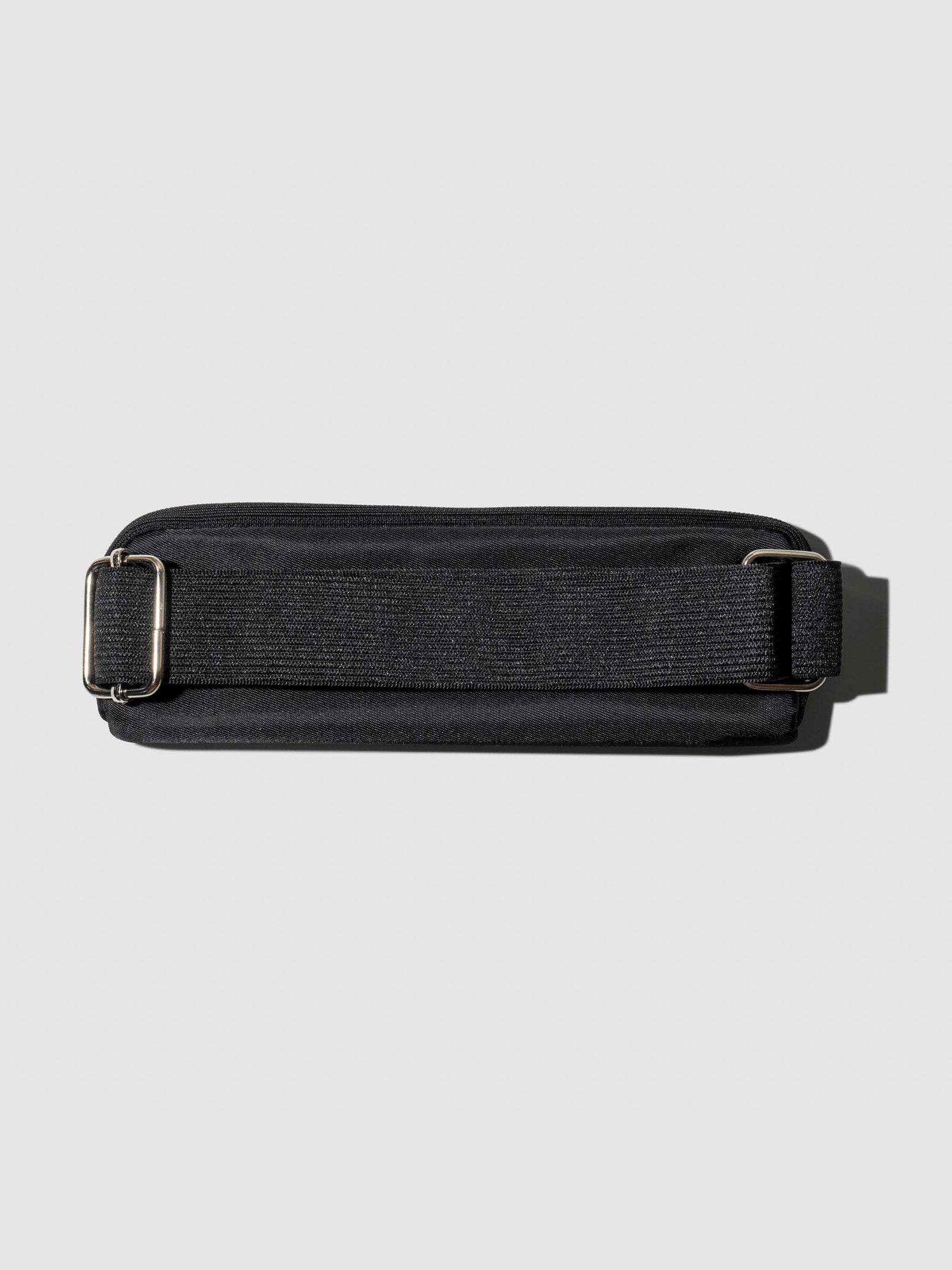 Notebook pouch shown with its back facing forward to show the adjustable strap. Color shown is Avant Garde.